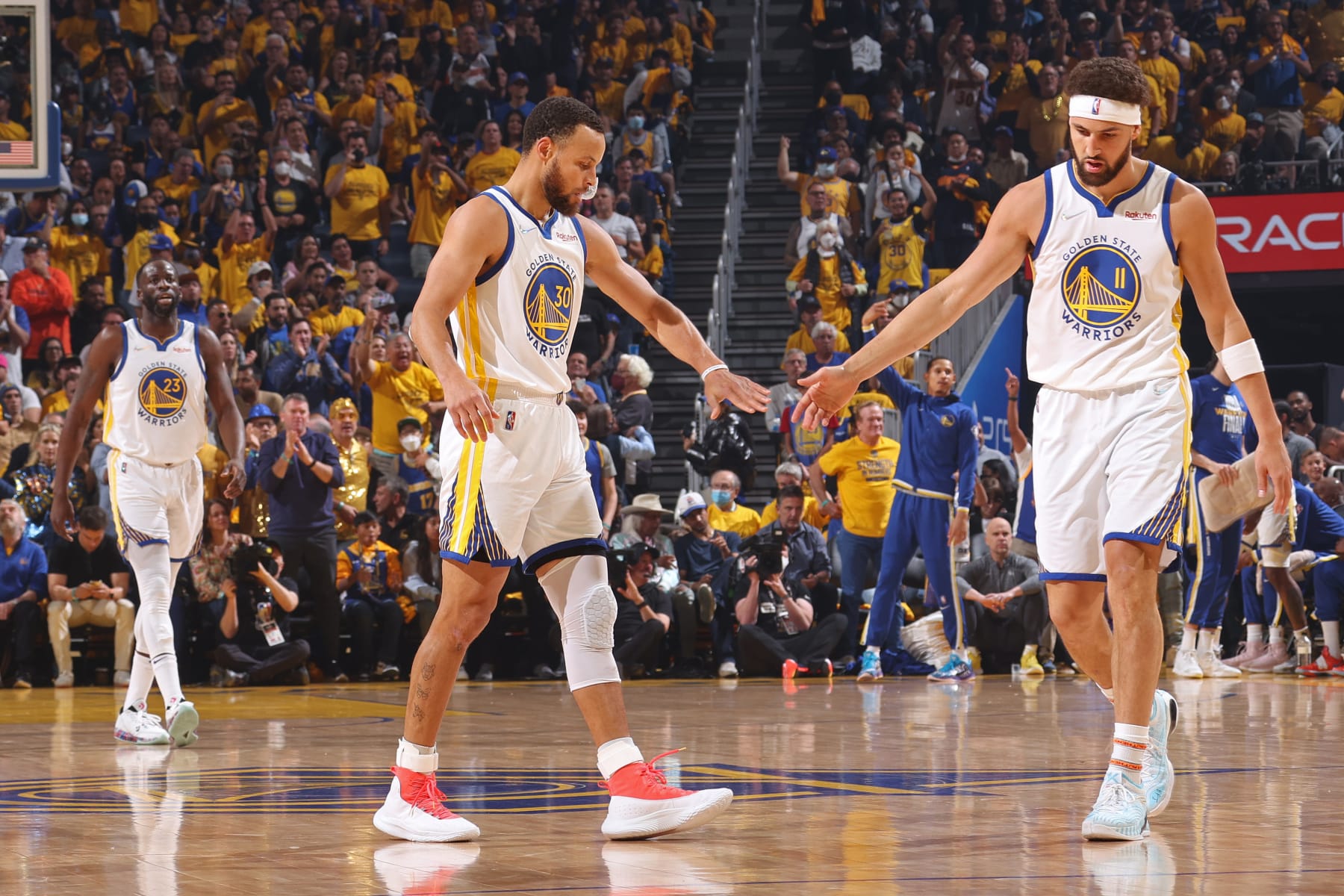 SAN FRANCISCO, CA - JUNE 13: Stephen Curry #30 of the Golden State Warriors high fives Klay Thompson #11 during Game Five of the 2022 NBA Finals on June 13, 2022 at Chase Center in San Francisco, California. NOTE TO USER: User expressly acknowledges and agrees that, by downloading and or using this photograph, user is consenting to the terms and conditions of Getty Images License Agreement. Mandatory Copyright Notice: Copyright 2022 NBAE (Photo by Nathaniel S. Butler/NBAE via Getty Images)