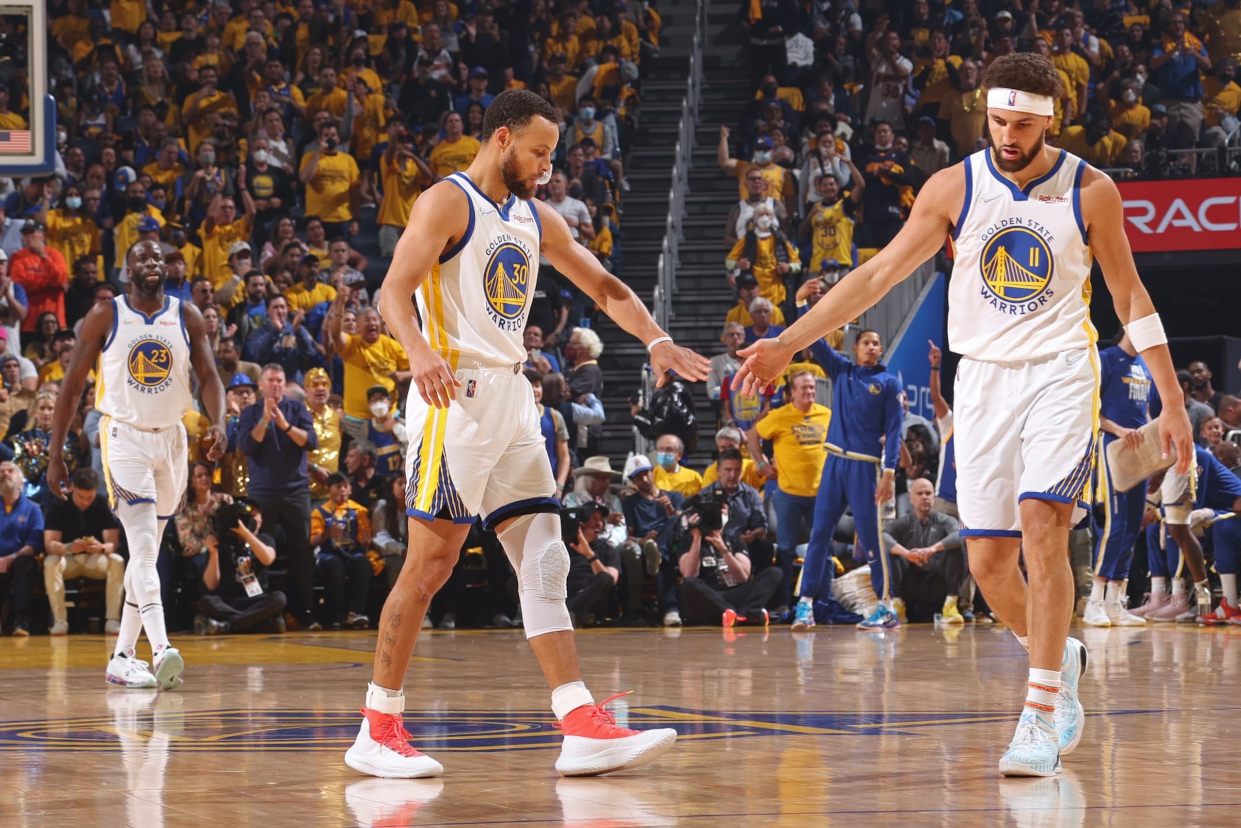 SAN FRANCISCO, CA - JUNE 13: Stephen Curry #30 of the Golden State Warriors high fives Klay Thompson #11 during Game Five of the 2022 NBA Finals on June 13, 2022 at Chase Center in San Francisco, California. NOTE TO USER: User expressly acknowledges and agrees that, by downloading and or using this photograph, user is consenting to the terms and conditions of Getty Images License Agreement. Mandatory Copyright Notice: Copyright 2022 NBAE (Photo by Nathaniel S. Butler/NBAE via Getty Images)