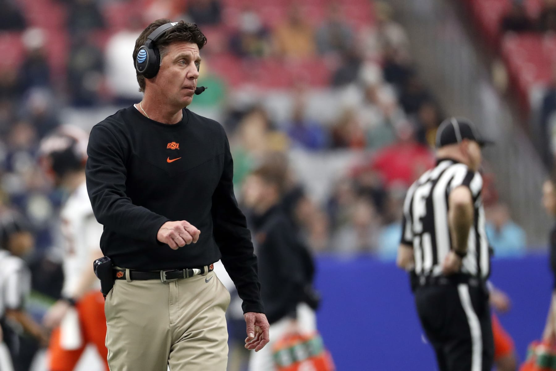GLENDALE, ARIZONA - JANUARY 01: Head coach Mike Gundy of the Oklahoma State Cowboys stands on the sideline during the second half of the PlayStation Fiesta Bowl against the Notre Dame Fighting Irish at State Farm Stadium on January 01, 2022 in Glendale, Arizona. The Cowboys defeated the Fighting Irish 37-35.  (Photo by Chris Coduto/Getty Images)