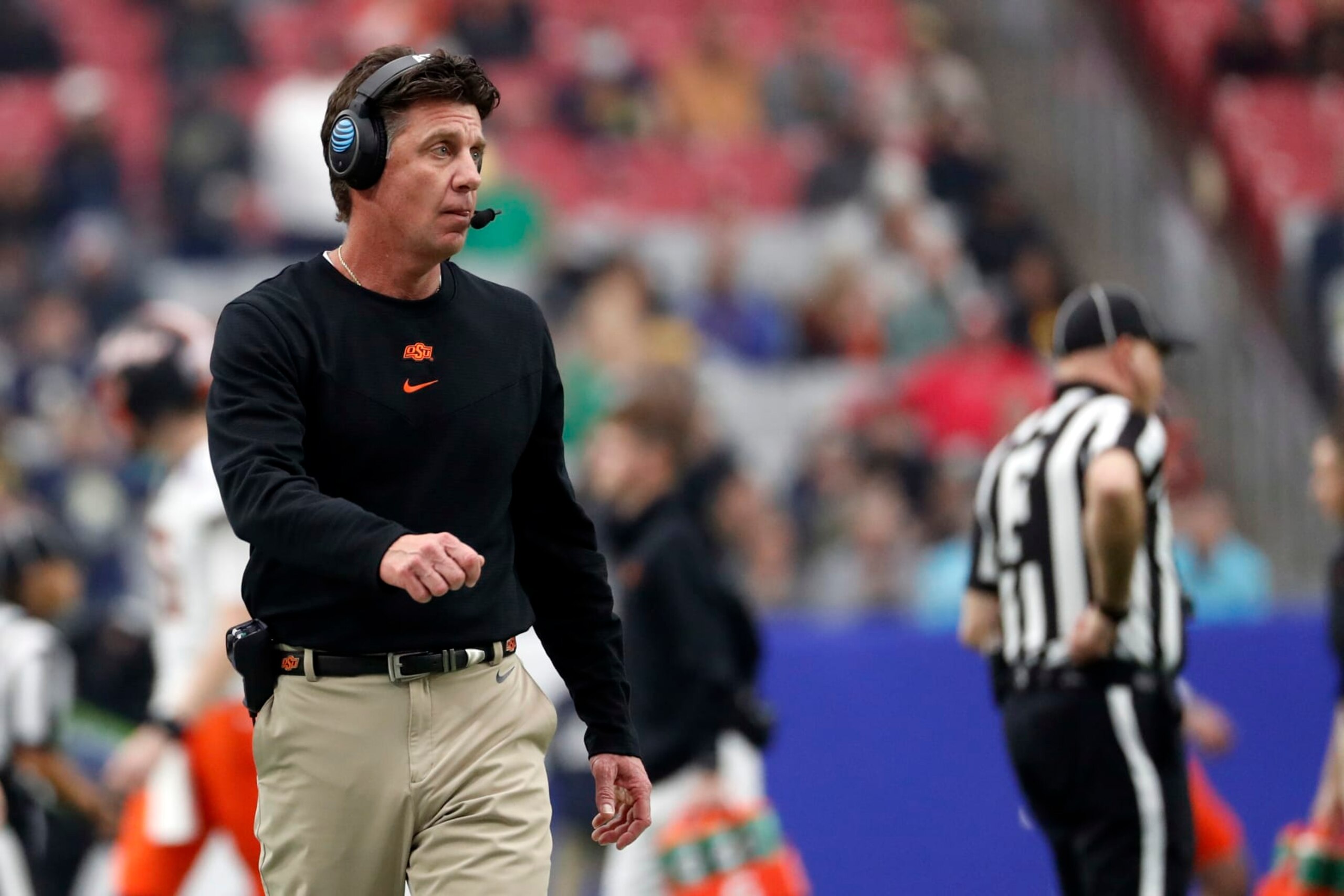 GLENDALE, ARIZONA - JANUARY 01: Head coach Mike Gundy of the Oklahoma State Cowboys stands on the sideline during the second half of the PlayStation Fiesta Bowl against the Notre Dame Fighting Irish at State Farm Stadium on January 01, 2022 in Glendale, Arizona. The Cowboys defeated the Fighting Irish 37-35.  (Photo by Chris Coduto/Getty Images)