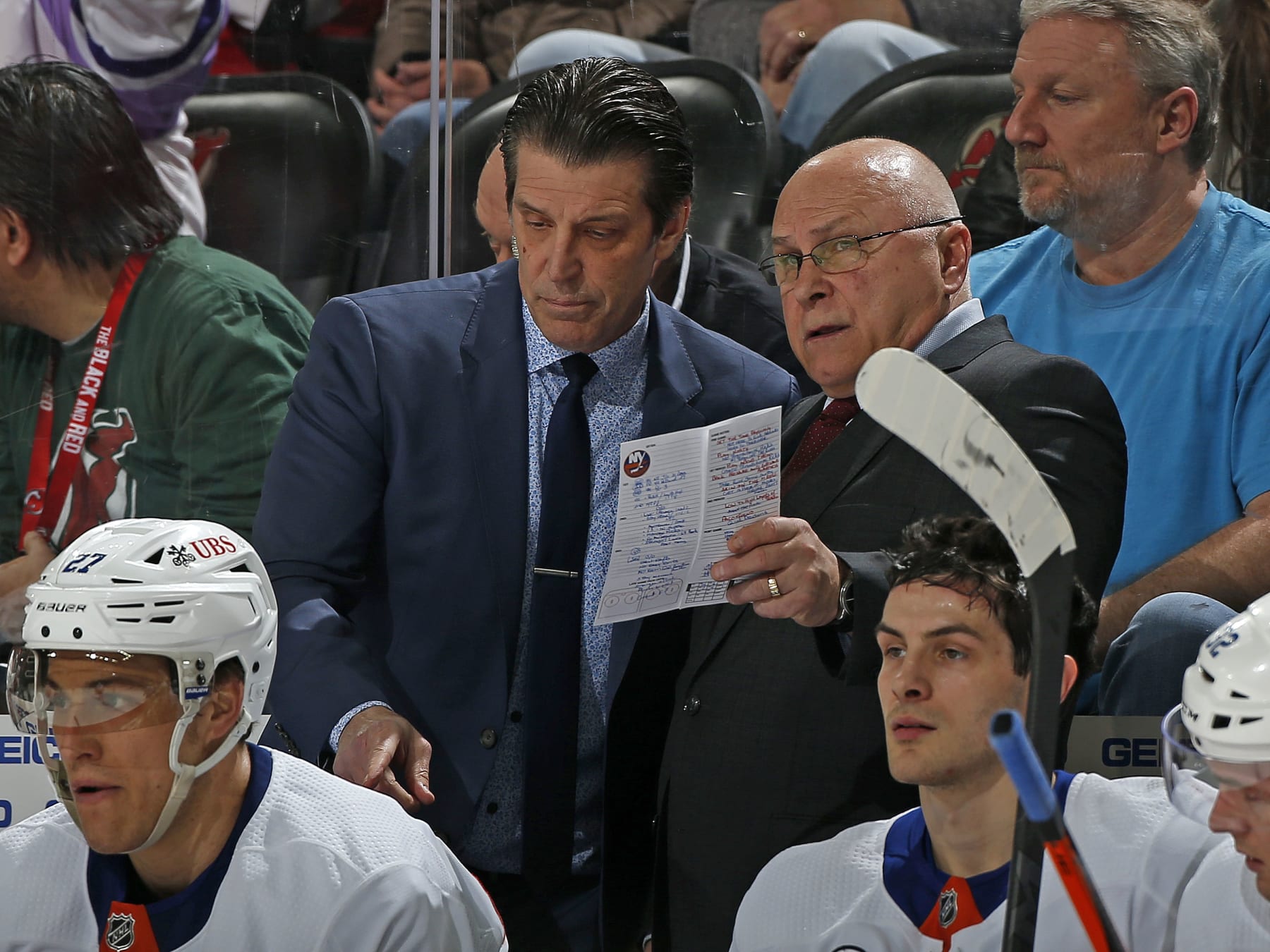 NEWARK, NJ - APRIL 03: New York Islanders head coach Barry Trotz talks to associate coach Lane Lambert during the third period against the New Jersey Devils at the Prudential Center on April 3, 2022 in Newark, New Jersey. The Islanders defeated the Devils 4-3. (Photo by Christopher Pasatieri/NHLI via Getty Images)