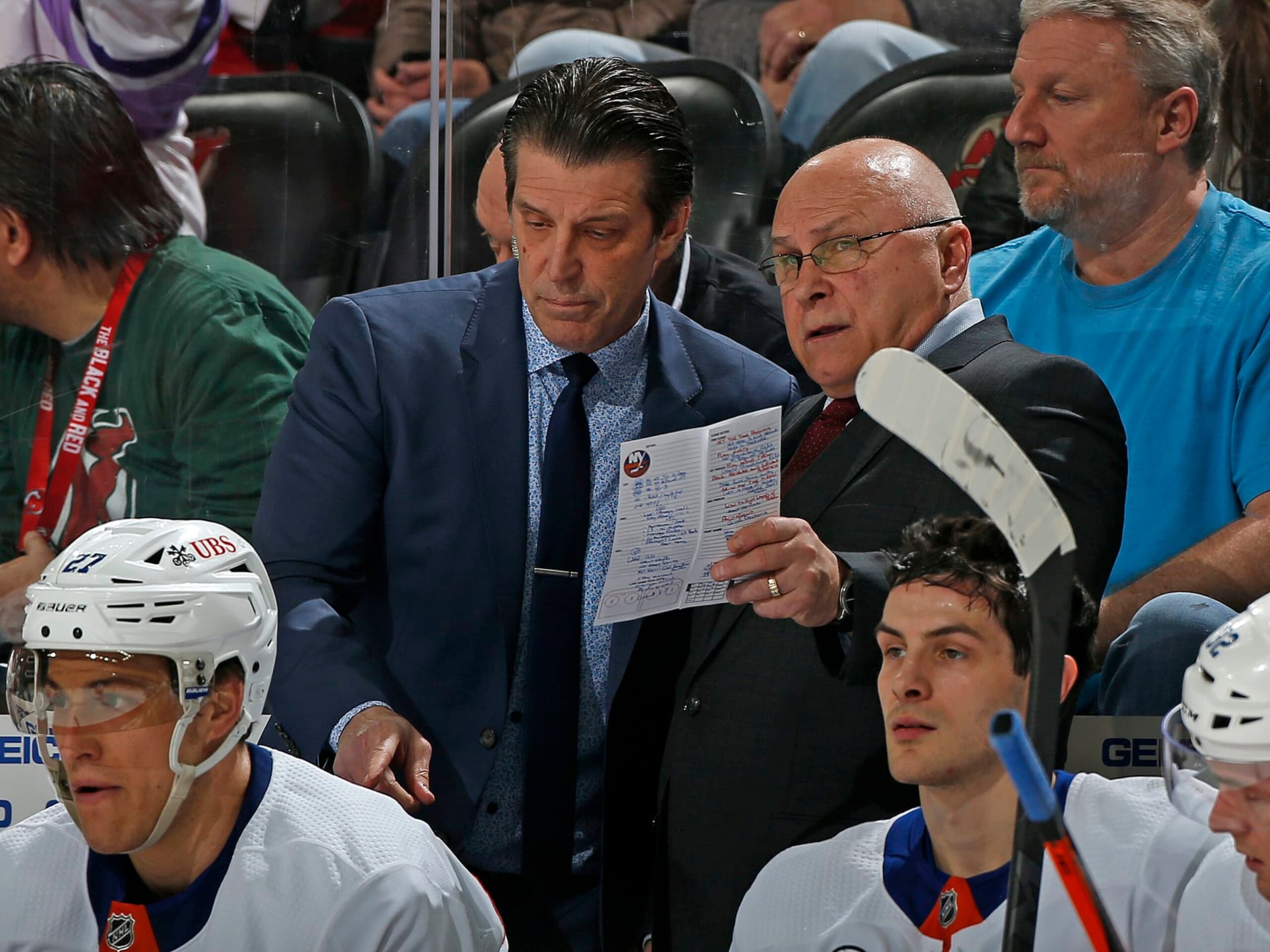 NEWARK, NJ - APRIL 03: New York Islanders head coach Barry Trotz talks to associate coach Lane Lambert during the third period against the New Jersey Devils at the Prudential Center on April 3, 2022 in Newark, New Jersey. The Islanders defeated the Devils 4-3. (Photo by Christopher Pasatieri/NHLI via Getty Images)