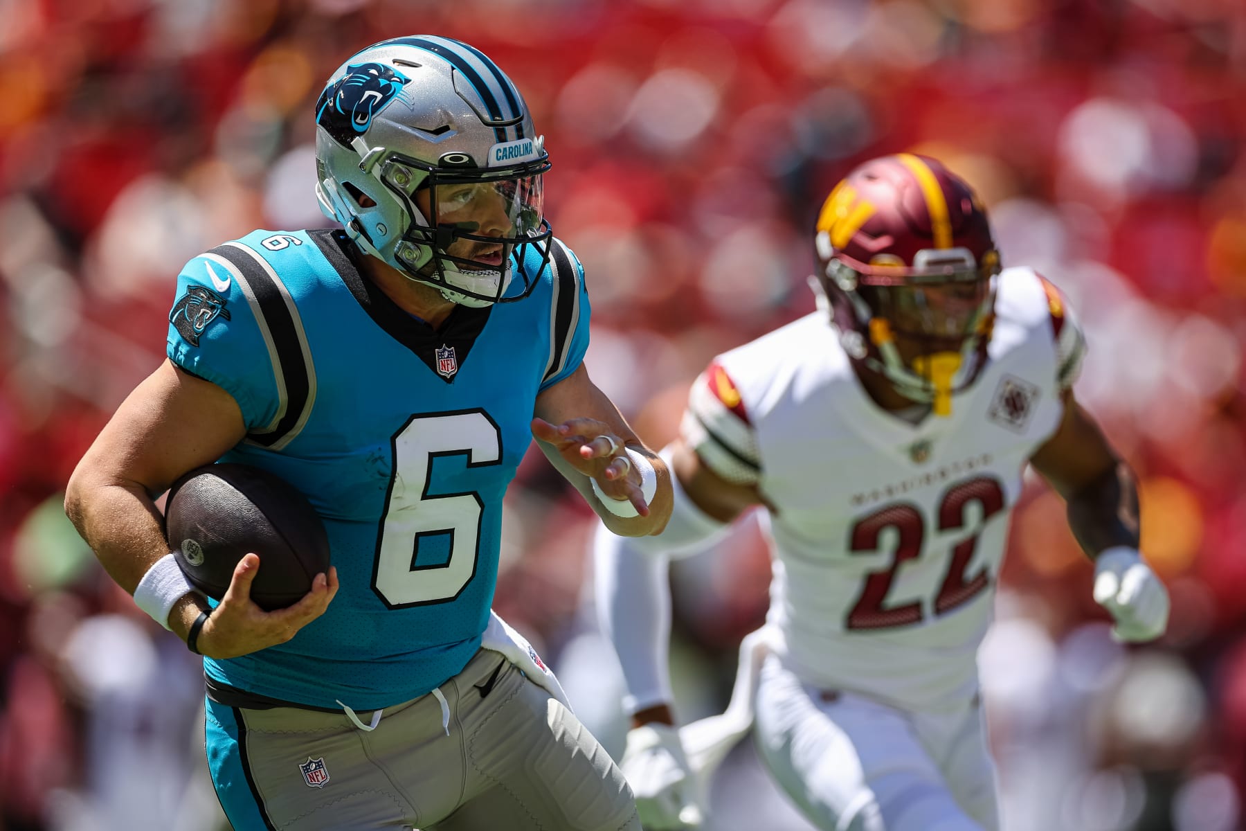 LANDOVER, MD - AUGUST 13: Baker Mayfield #6 of the Carolina Panthers carries the ball as Darrick Forrest #22 of the Washington Commanders defends during the first half of the preseason game at FedExField on August 13, 2022 in Landover, Maryland. (Photo by Scott Taetsch/Getty Images) LANDOVER, MD - AUGUST 13: Baker Mayfield #6 of the Carolina Panthers carries the ball as Darrick Forrest #22 of the Washington Commanders defends during the first half of the preseason game at FedExField on August 13, 2022 in Landover, Maryland. (Photo by Scott Taetsch/Getty Images)