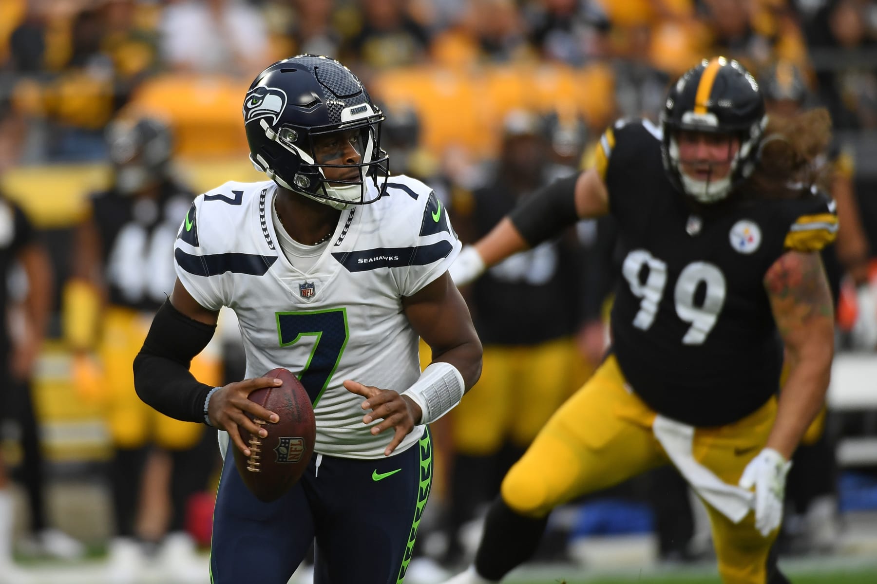 PITTSBURGH, PA - AUGUST 13: Geno Smith #7 of the Seattle Seahawks scrambles out of the pocket under pressure from Henry Mondeaux #99 of the Pittsburgh Steelers in the first quarter during a preseason game at Acrisure Stadium on August 13, 2022 in Pittsburgh, Pennsylvania. (Photo by Justin Berl/Getty Images)