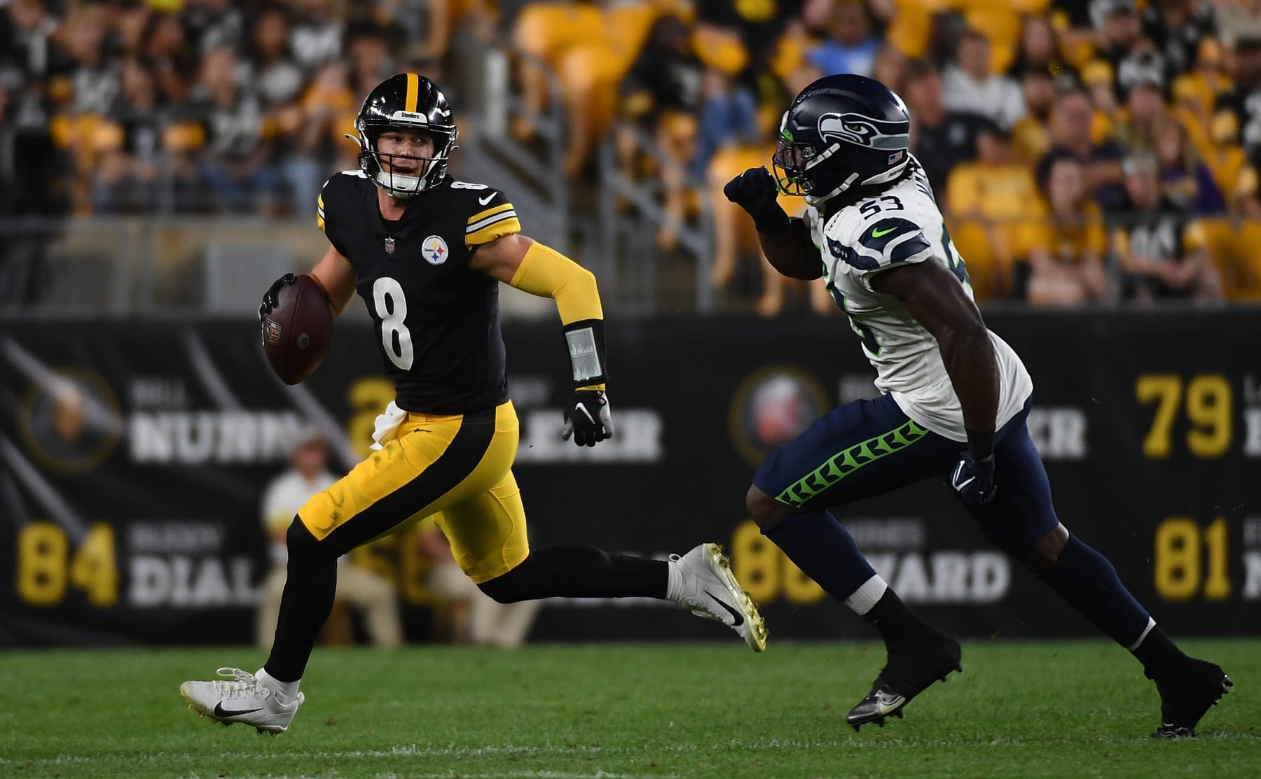 PITTSBURGH, PA - AUGUST 13: Kenny Pickett #8 of the Pittsburgh Steelers scrambles out of the pocket under pressure from Boye Mafe #53 of the Seattle Seahawks in the fourth quarter during a preseason game at Acrisure Stadium on August 13, 2022 in Pittsburgh, Pennsylvania. (Photo by Justin Berl/Getty Images)