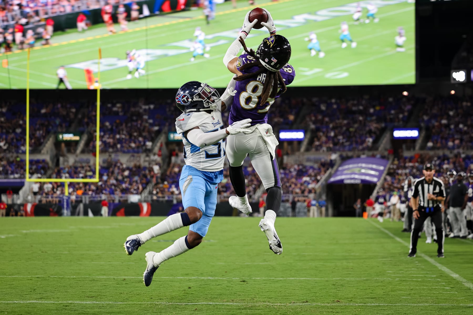 BALTIMORE, MD - AUGUST 11: Shemar Bridges #85 of the Baltimore Ravens catches a pass for a touchdown against Chris Jackson #35 of the Tennessee Titans during the first half at M&T Bank Stadium on August 11, 2022 in Baltimore, Maryland. (Photo by Scott Taetsch/Getty Images)