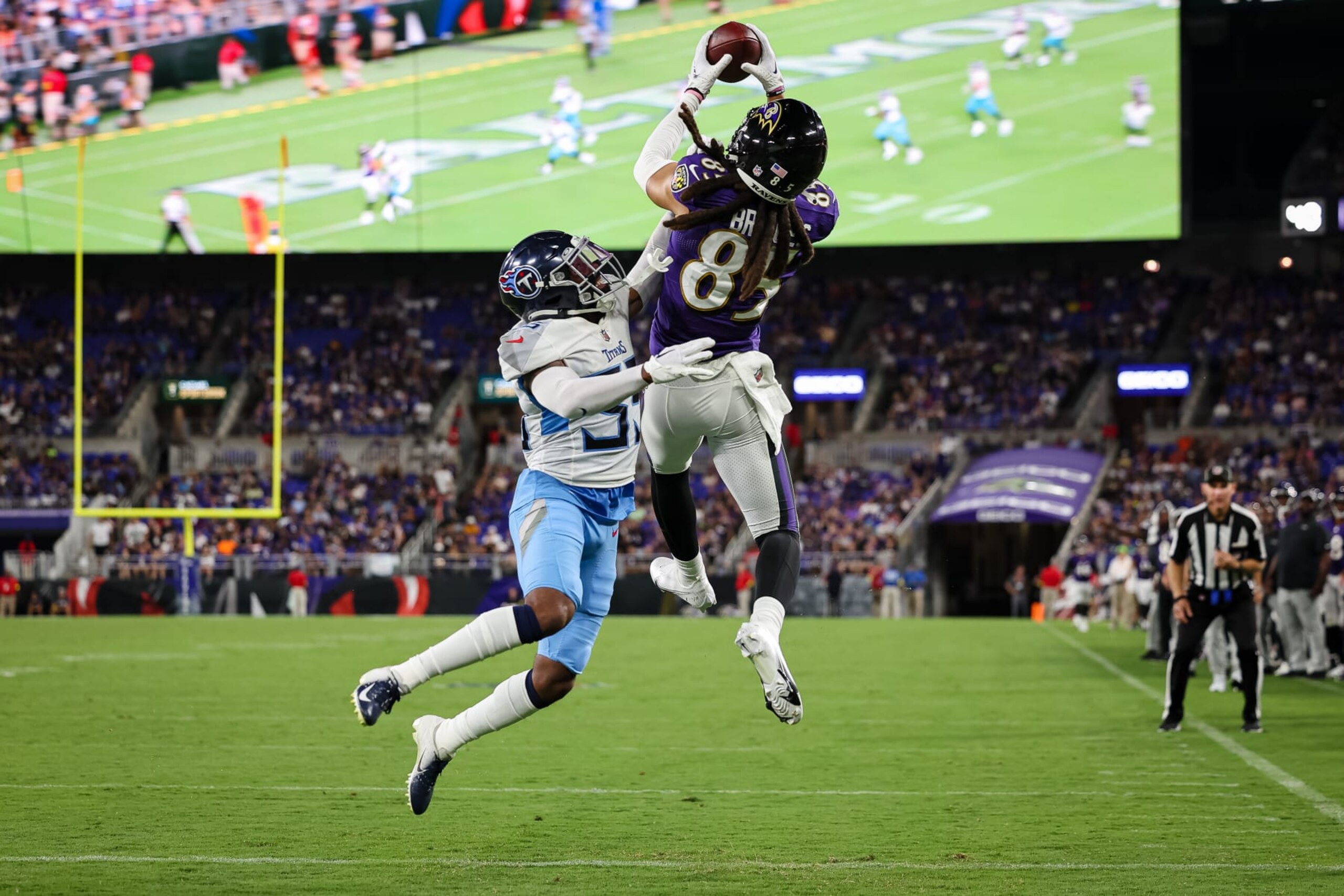 BALTIMORE, MD - AUGUST 11: Shemar Bridges #85 of the Baltimore Ravens catches a pass for a touchdown against Chris Jackson #35 of the Tennessee Titans during the first half at M&T Bank Stadium on August 11, 2022 in Baltimore, Maryland. (Photo by Scott Taetsch/Getty Images)