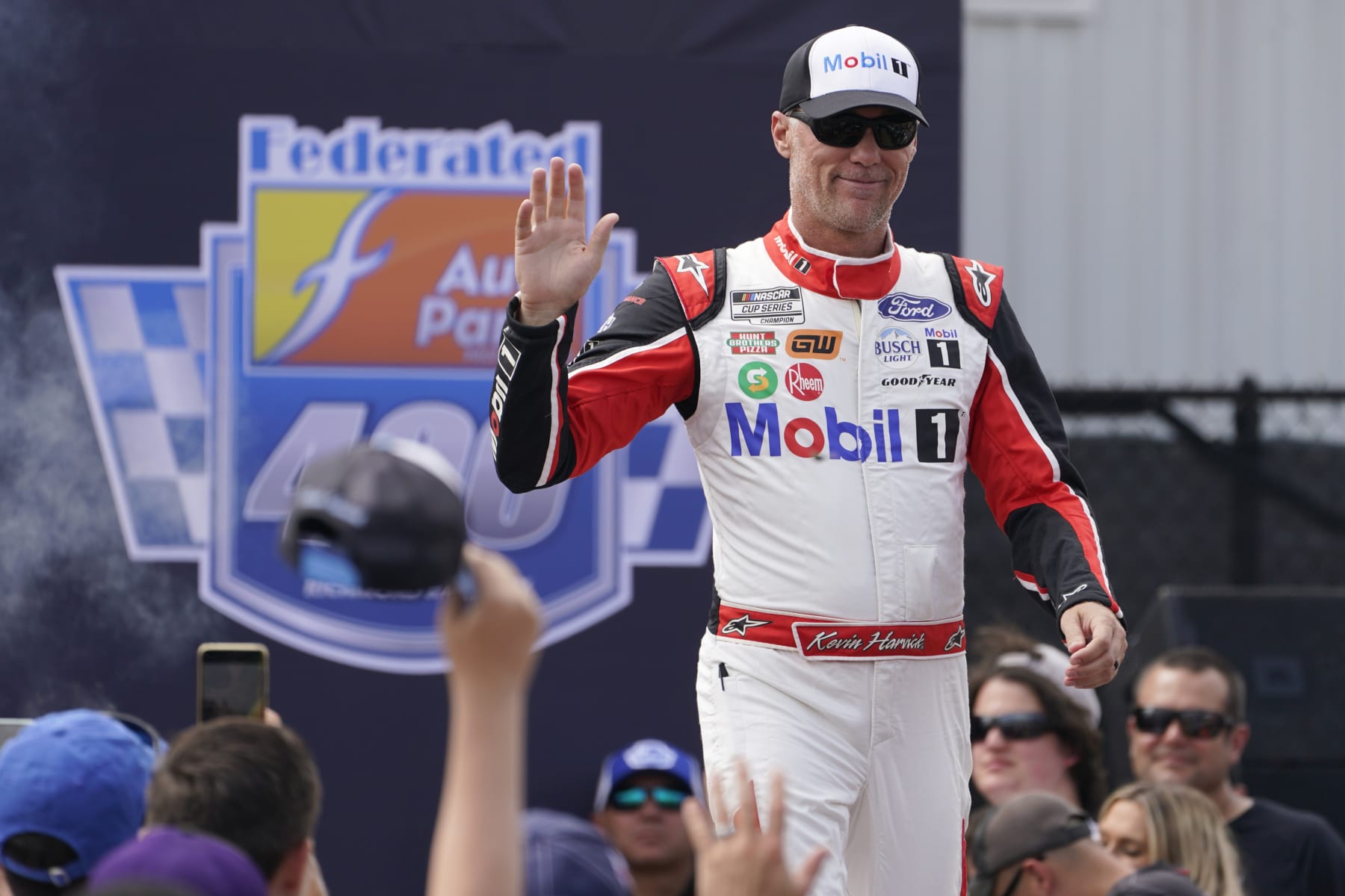 Kevin Harvick greets fans during driver introductions prior to the start of a NASCAR Cup Series auto race at Richmond Raceway, Sunday, Aug. 14, 2022, in Richmond, Va. (AP Photo/Steve Helber)