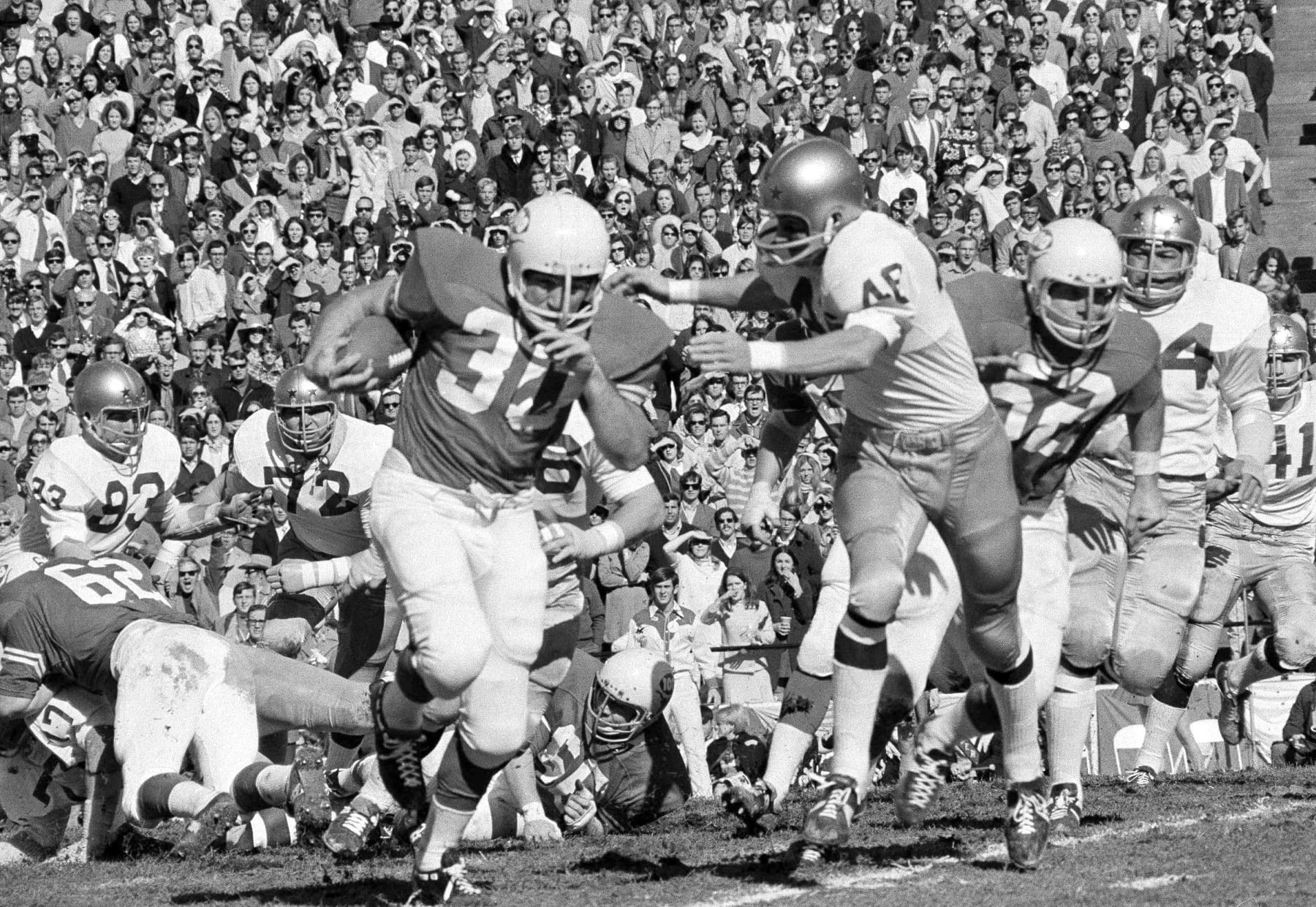 University of Texas fullback Steve Worster (30) rambles down the field for a gain in first quarter of their game against Notre Dame in Dallas, Texas on Jan. 1, 1970. Notre Dame defensive halfback John Gasser (46) downed Worster. (AP Photo)