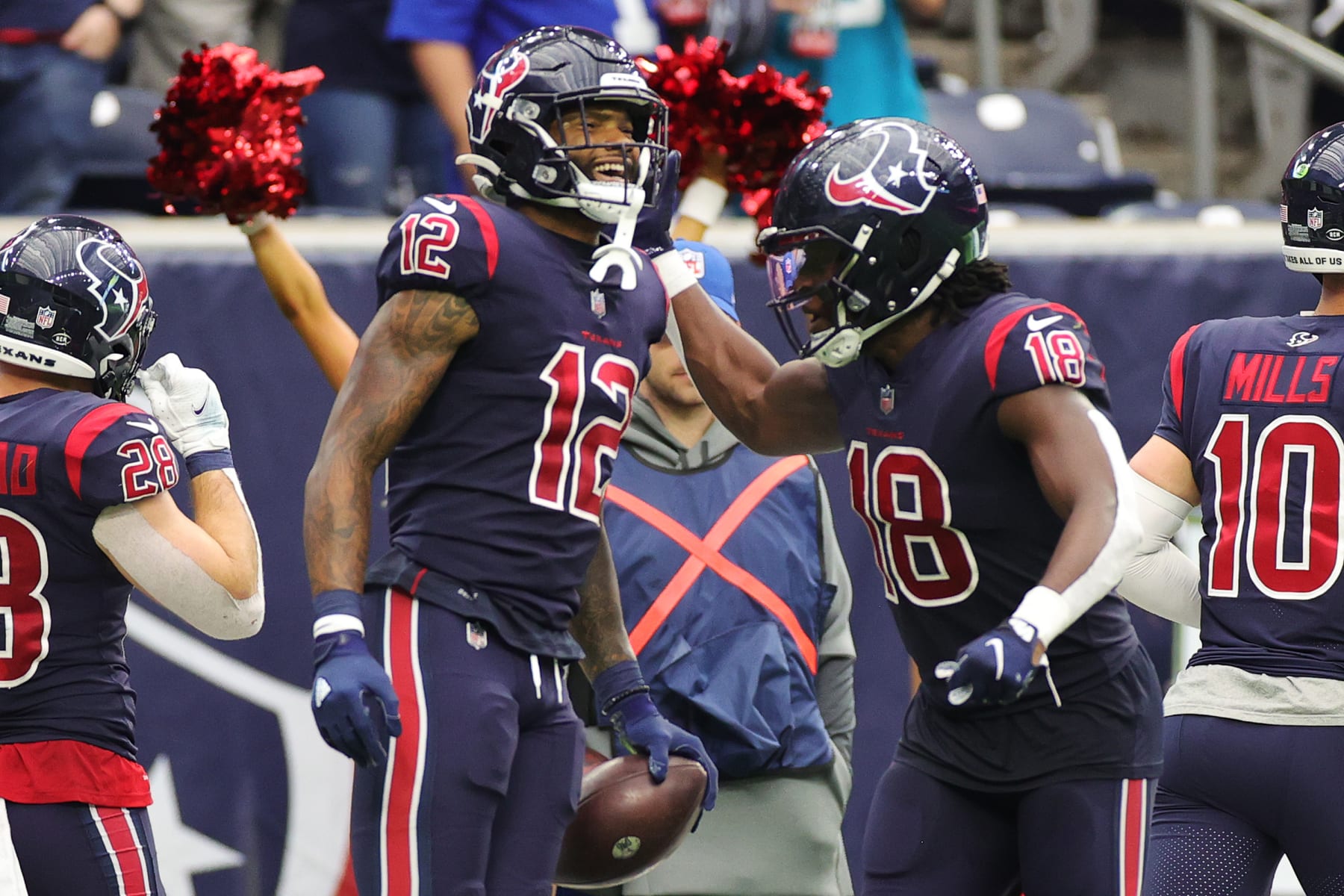 HOUSTON, TEXAS - DECEMBER 26: Nico Collins #12 of the Houston Texans celebrates with Pharaoh Brown #85 after catch a pass for a touchdown during the fourth quarter against the Los Angeles Chargers at NRG Stadium on December 26, 2021 in Houston, Texas. (Photo by Carmen Mandato/Getty Images)