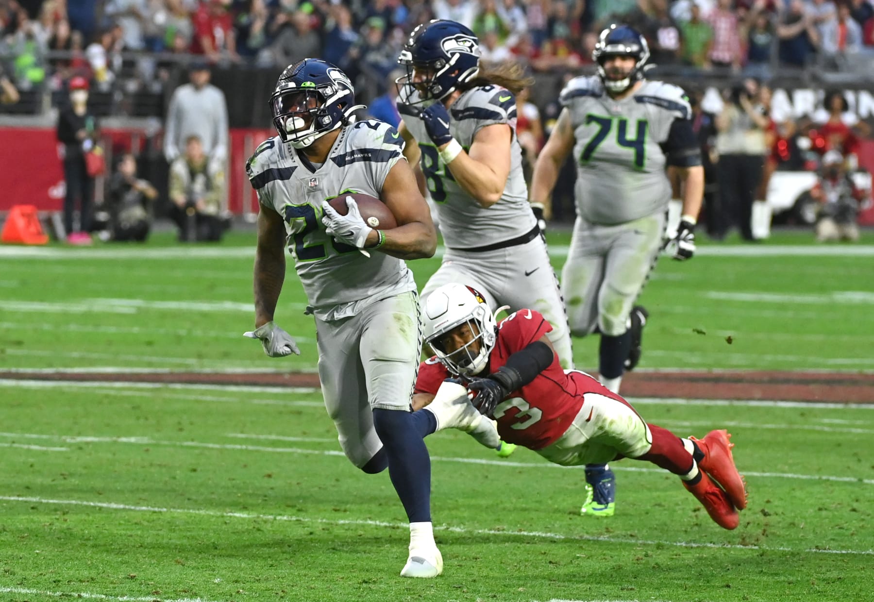 GLENDALE, ARIZONA - JANUARY 09: Rashaad Penny #20 of the Seattle Seahawks runs the ball for a touchdown during the fourth quarter against the Arizona Cardinals at State Farm Stadium on January 09, 2022 in Glendale, Arizona. (Photo by Norm Hall/Getty Images)