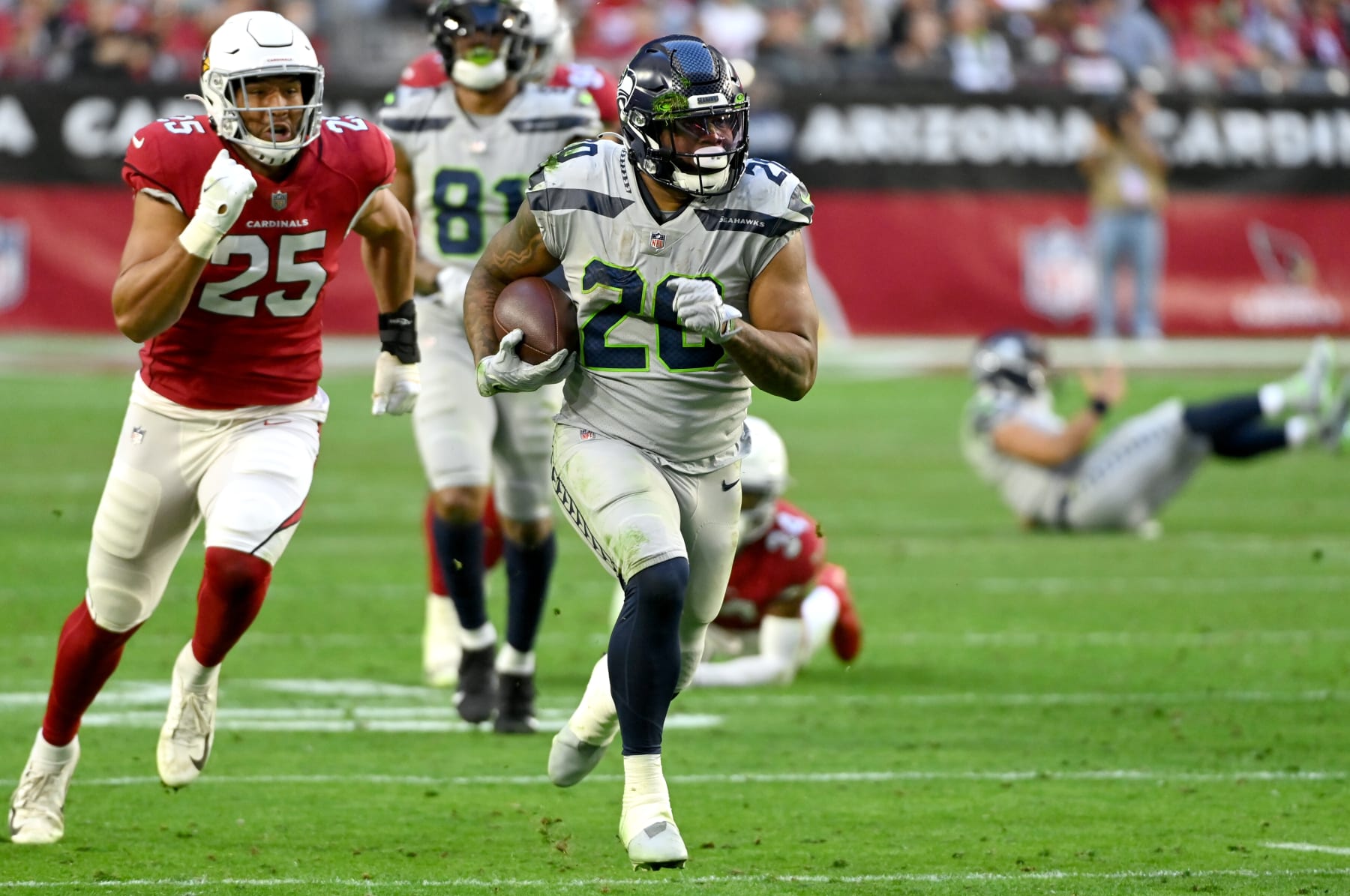 GLENDALE, ARIZONA - JANUARY 09: Rashaad Penny #20 of the Seattle Seahawks runs the ball for a first down during the third quarter against the Arizona Cardinals at State Farm Stadium on January 09, 2022 in Glendale, Arizona. (Photo by Norm Hall/Getty Images)