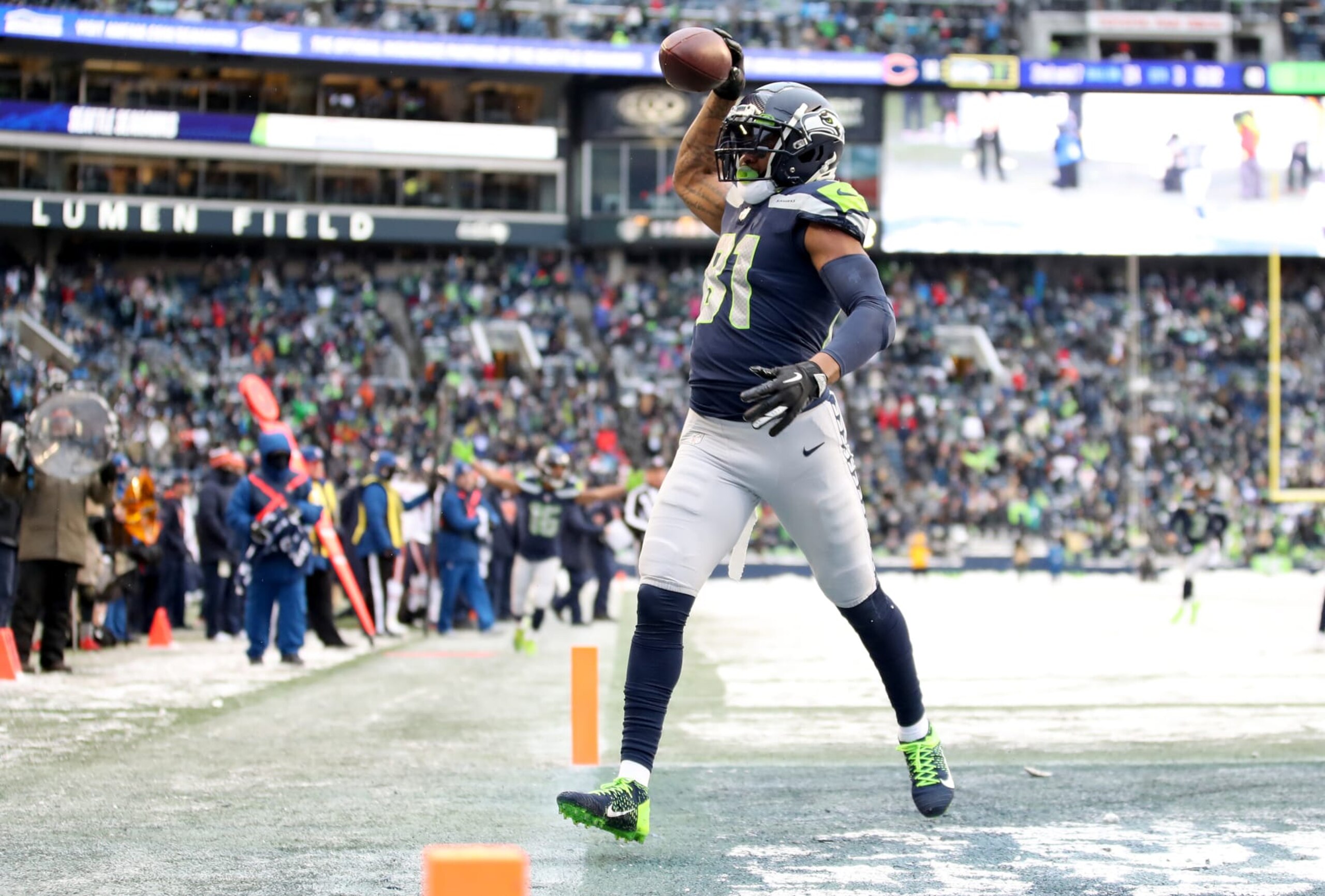 SEATTLE, WASHINGTON - DECEMBER 26: Gerald Everett #81 of the Seattle Seahawks celebrates after scoring a touchdown during the third quarter against the Chicago Bears at Lumen Field on December 26, 2021 in Seattle, Washington. (Photo by Steph Chambers/Getty Images)