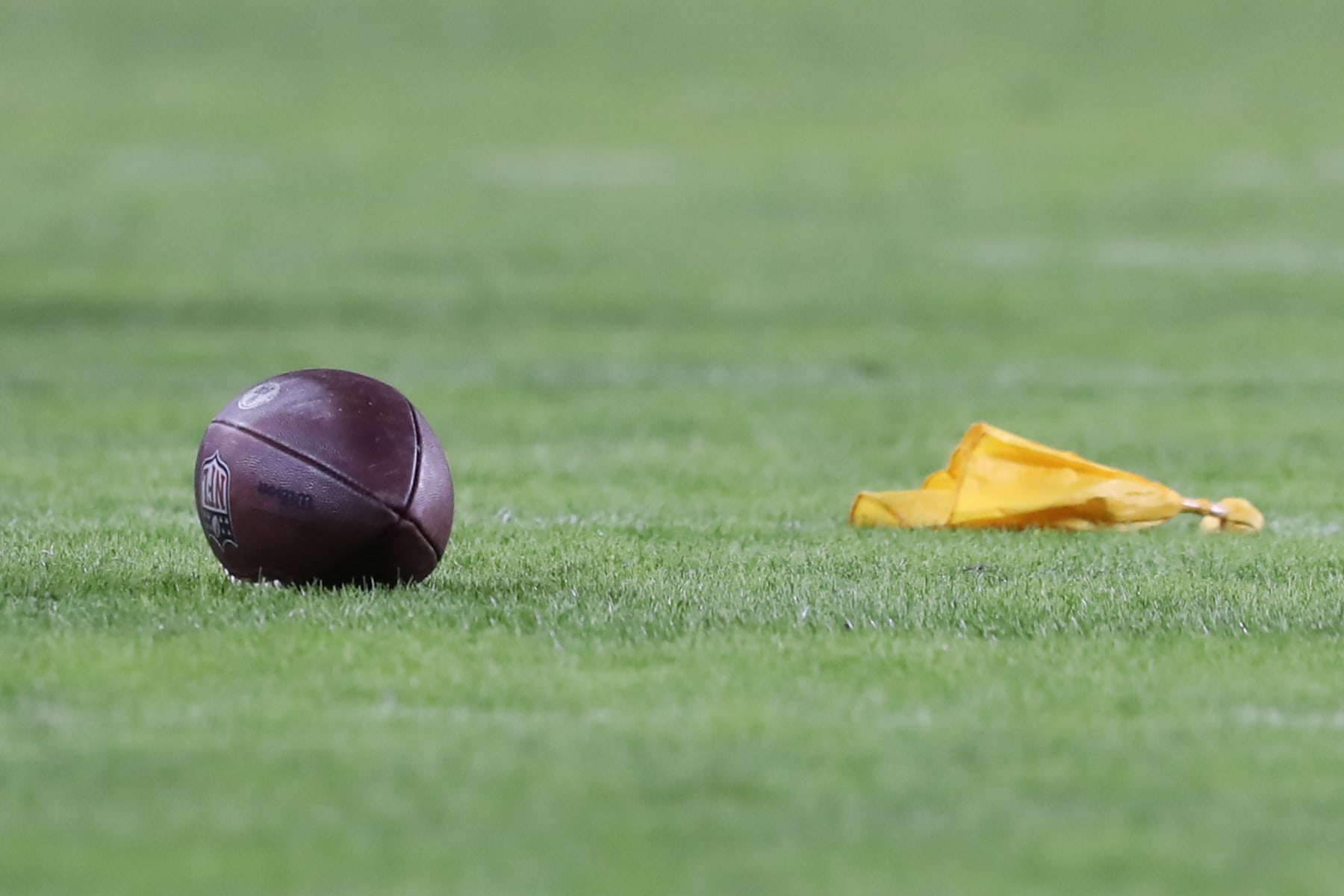 KANSAS CITY, MO - DECEMBER 26: A yellow penalty flag and football sit on the field in the third quarter of an NFL game between the Pittsburgh Steelers and Kansas City Chiefs on Dec 26, 2021 at GEHA Field at Arrowhead Stadium in Kansas City, MO. (Photo by Scott Winters/Icon Sportswire via Getty Images)
