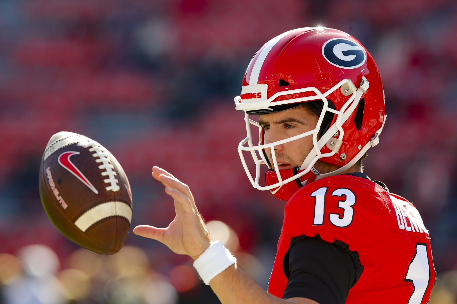ATHENS, GA - NOVEMBER 20: Stetson Bennett #13 of the Georgia Bulldogs warms up prior to the game against the Charleston Southern Buccaneers at Sanford Stadium on November 20, 2021 in Athens, Georgia. (Photo by Todd Kirkland/Getty Images)