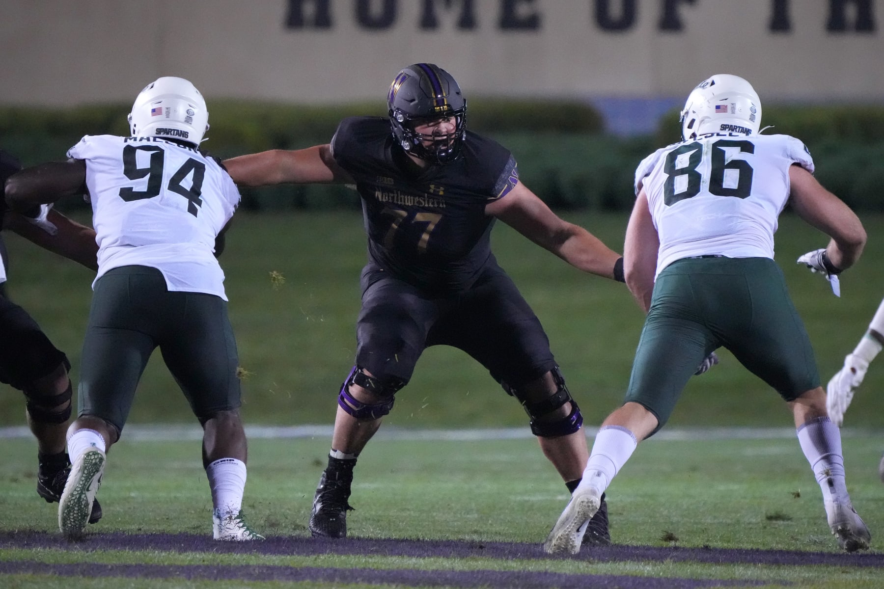 EVANSTON, IL - SEPTEMBER 03: Northwestern Wildcats offensive lineman Peter Skoronski (77) battles with Michigan State Spartans defensive tackle Dashaun Mallory (94) and defensive end Drew Beesley (86) during a game between the Northwestern Wildcats and the Michigan State Spartans on September 3, 2021 at Ryan Field, in Evanston, IL.  (Photo by Robin Alam/Icon Sportswire via Getty Images)