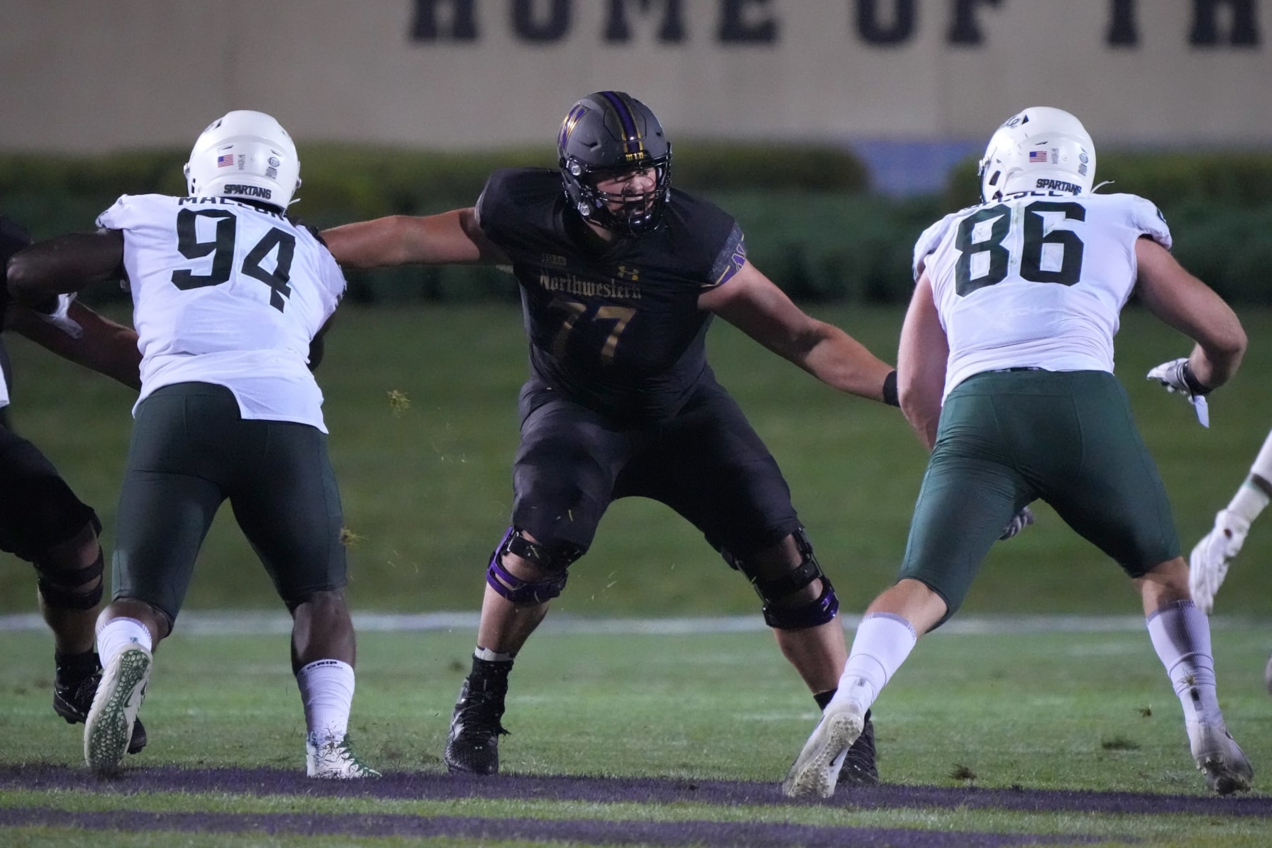 EVANSTON, IL - SEPTEMBER 03: Northwestern Wildcats offensive lineman Peter Skoronski (77) battles with Michigan State Spartans defensive tackle Dashaun Mallory (94) and defensive end Drew Beesley (86) during a game between the Northwestern Wildcats and the Michigan State Spartans on September 3, 2021 at Ryan Field, in Evanston, IL.  (Photo by Robin Alam/Icon Sportswire via Getty Images)