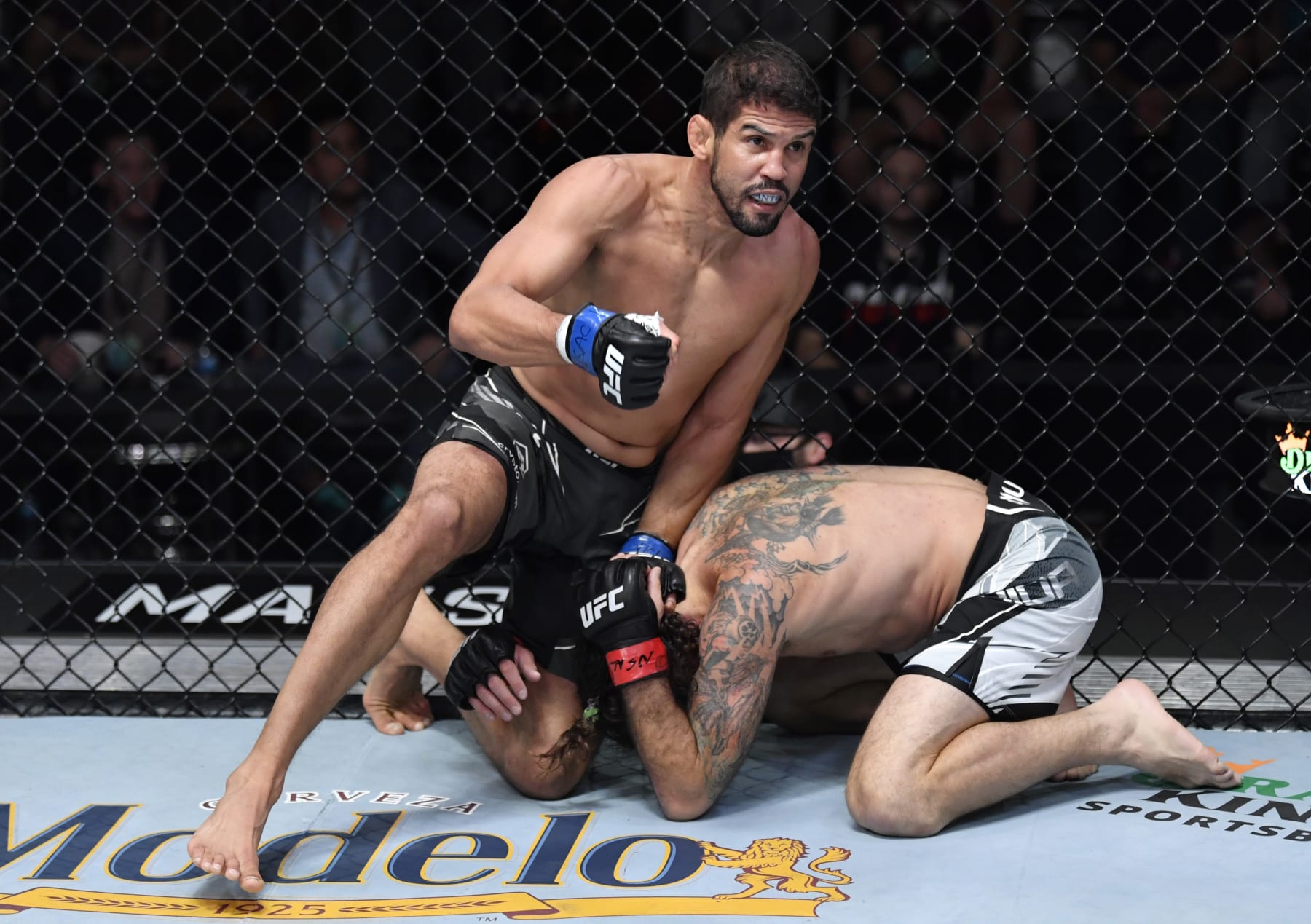 LAS VEGAS, NEVADA - DECEMBER 04: (L-R) Leonardo Santos of Brazil punches Clay Guida in their lightweight fight during the UFC Fight Night event at UFC APEX on December 04, 2021 in Las Vegas, Nevada. (Photo by Jeff Bottari/Zuffa LLC) LAS VEGAS, NEVADA - DECEMBER 04: (L-R) Leonardo Santos of Brazil punches Clay Guida in their lightweight fight during the UFC Fight Night event at UFC APEX on December 04, 2021 in Las Vegas, Nevada. (Photo by Jeff Bottari/Zuffa LLC)