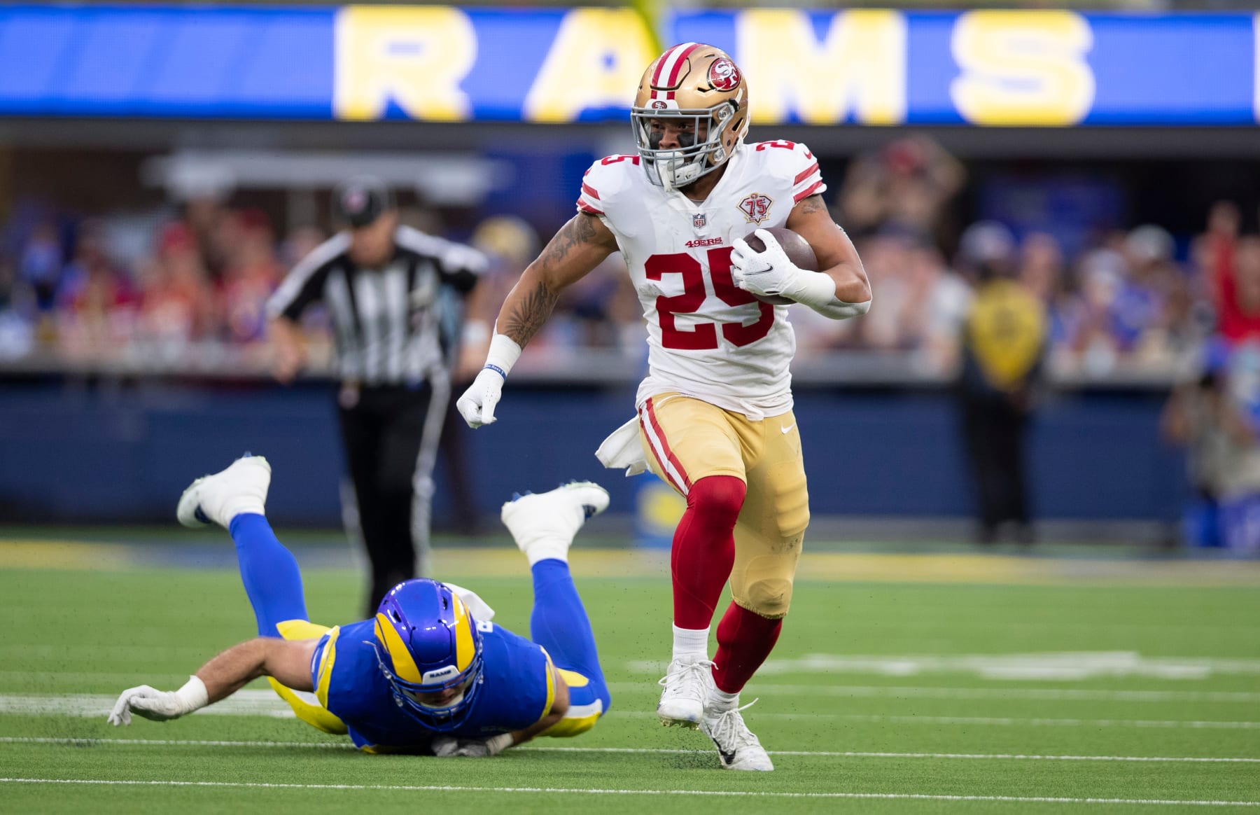 INGLEWOOD, CA - JANUARY 30: Elijah Mitchell #25 of the San Francisco 49ers runs after making a catch during the game against the Los Angeles Rams at SoFi Stadium on January 30, 2022 in Inglewood, California. The Rams defeated the 49ers 20-17. (Photo by Michael Zagaris/San Francisco 49ers/Getty Images)