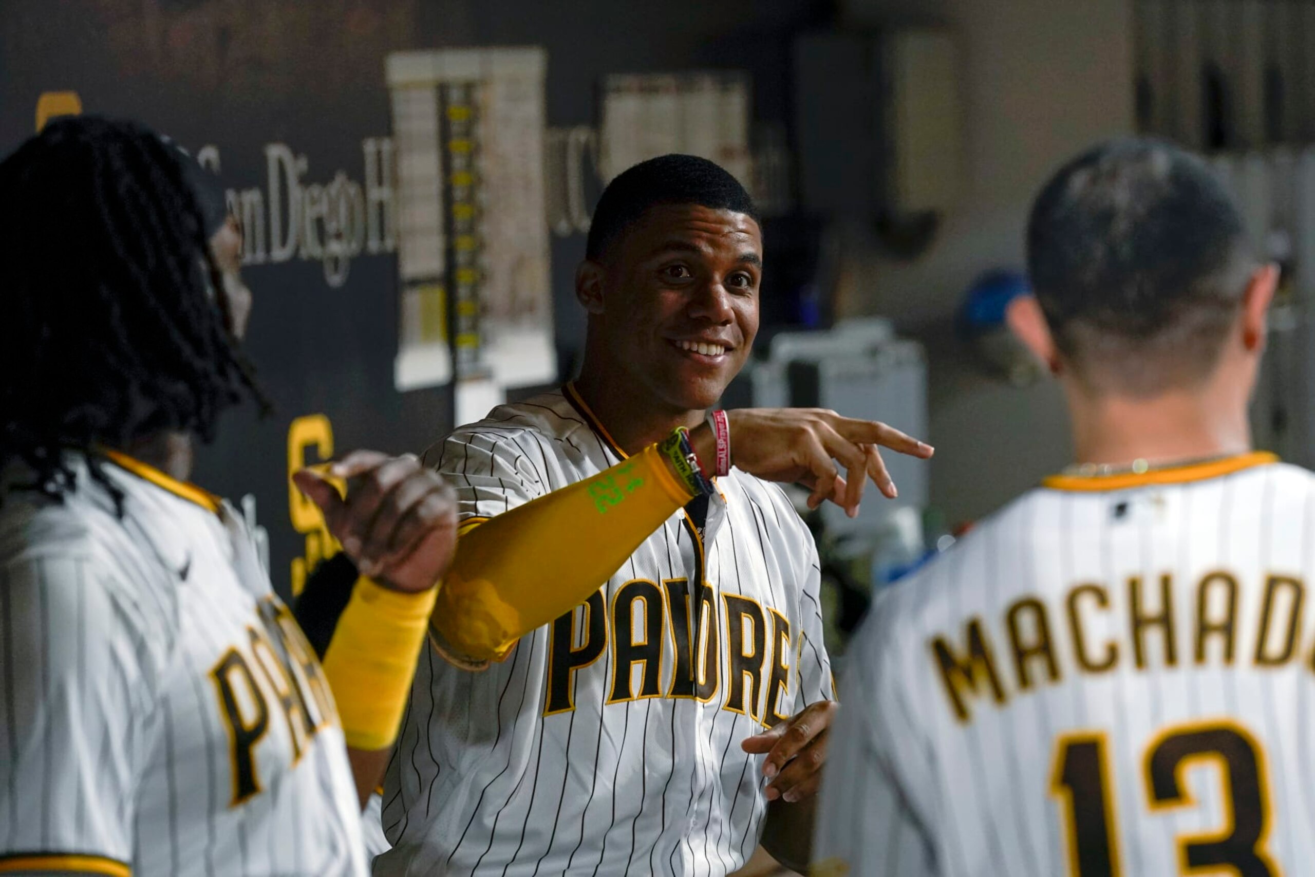 San Diego Padres right fielder Juan Soto, center, jokes with teammates third baseman Manny Machado, right, and first baseman Josh Bell during the fourth inning of the team's baseball game against the Colorado Rockies, Wednesday, Aug. 3, 2022, in San Diego. (AP Photo/Gregory Bull) San Diego Padres right fielder Juan Soto, center, jokes with teammates third baseman Manny Machado, right, and first baseman Josh Bell during the fourth inning of the team's baseball game against the Colorado Rockies, Wednesday, Aug. 3, 2022, in San Diego. (AP Photo/Gregory Bull)