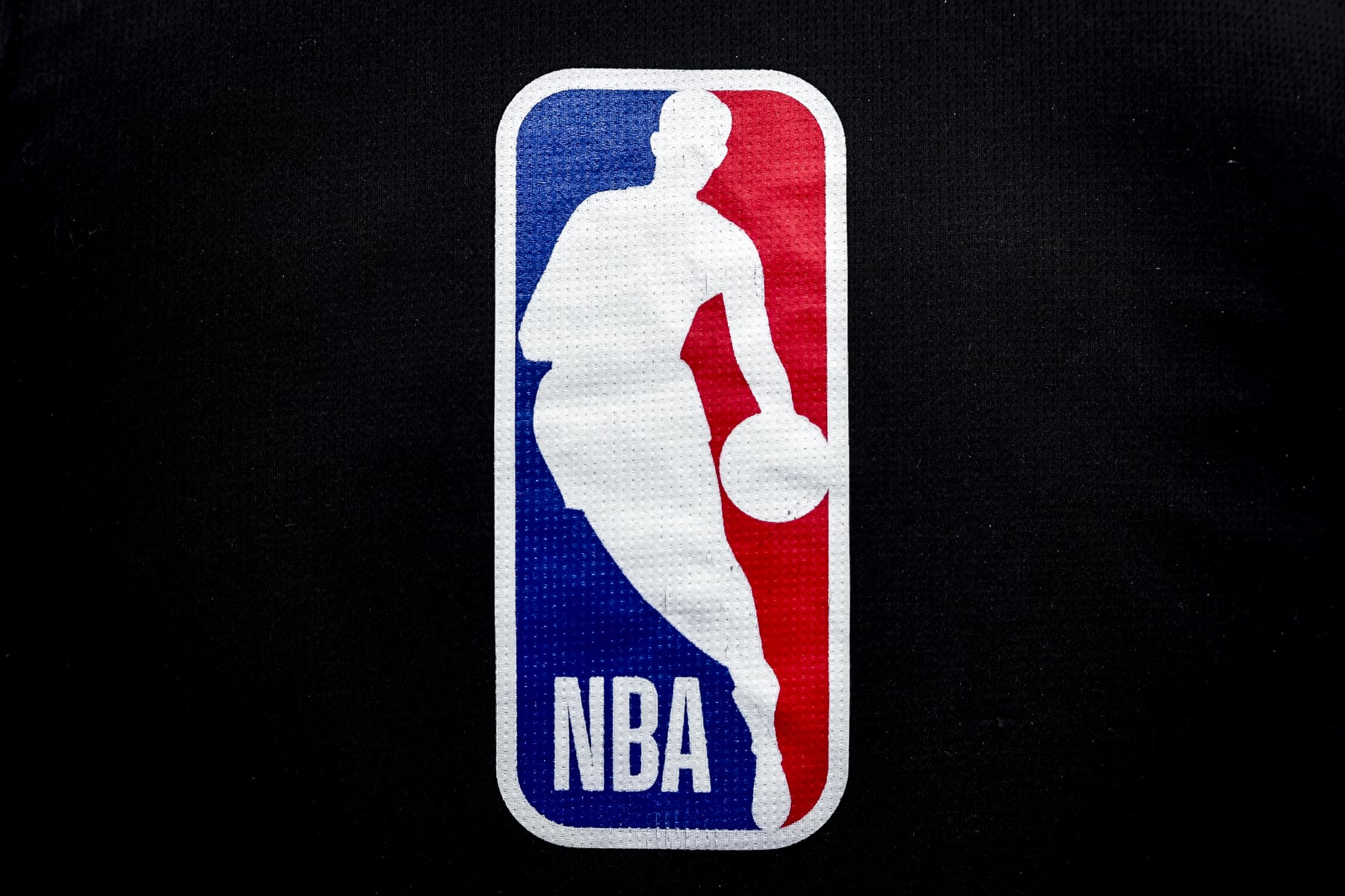 DETROIT, MICHIGAN - JANUARY 08: The NBA logo is pictured ahead of the game between the Detroit Pistons and Orlando Magic at Little Caesars Arena on January 08, 2022 in Detroit, Michigan. NOTE TO USER: User expressly acknowledges and agrees that, by downloading and or using this photograph, User is consenting to the terms and conditions of the Getty Images License Agreement. (Photo by Nic Antaya/Getty Images) DETROIT, MICHIGAN - JANUARY 08: The NBA logo is pictured ahead of the game between the Detroit Pistons and Orlando Magic at Little Caesars Arena on January 08, 2022 in Detroit, Michigan. NOTE TO USER: User expressly acknowledges and agrees that, by downloading and or using this photograph, User is consenting to the terms and conditions of the Getty Images License Agreement. (Photo by Nic Antaya/Getty Images)