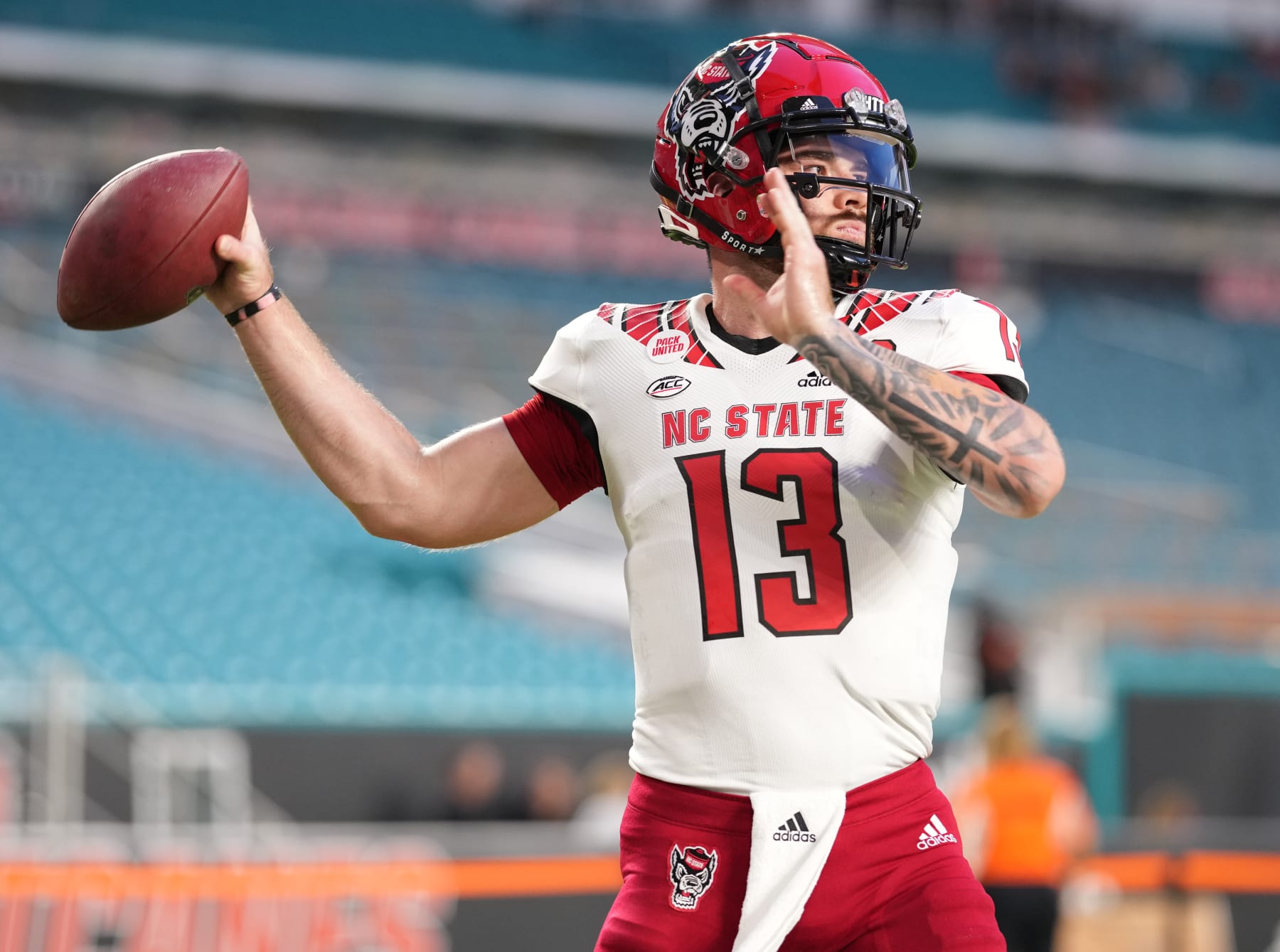 MIAMI GARDENS, FLORIDA - OCTOBER 23: Devin Leary #13 of the North Carolina State Wolfpack throws a pass during pregame warm ups prior to the game against theMiami Hurricanes at Hard Rock Stadium on October 23, 2021 in Miami Gardens, Florida. (Photo by Mark Brown/Getty Images)
