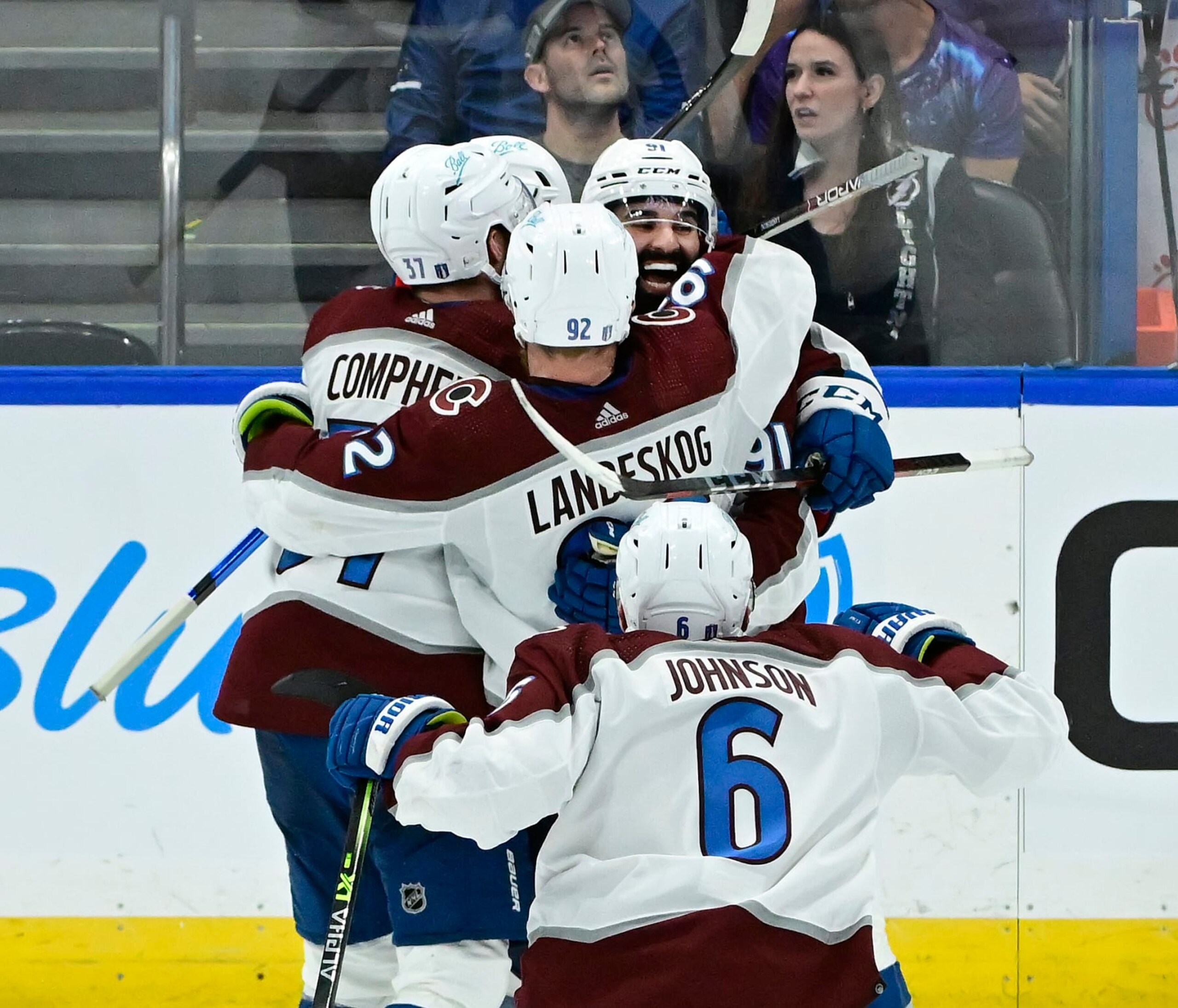 TAMPA, FL - JUNE 22: Colorado Avalanche left wing J.T. Compher (37), Colorado Avalanche left wing Gabriel Landeskog (92) and Colorado Avalanche defenseman Erik Johnson (6) swarm Colorado Avalanche center Nazem Kadri (91) after Kadri scored the game winning overtime goal against Tampa Bay Lightning goaltender Andrei Vasilevskiy (88) to win game four of the NHL Stanley Cup Finals 3-2 at Amalie Arena June 22, 2022. (Photo by Andy Cross/MediaNews Group/The Denver Post via Getty Images)