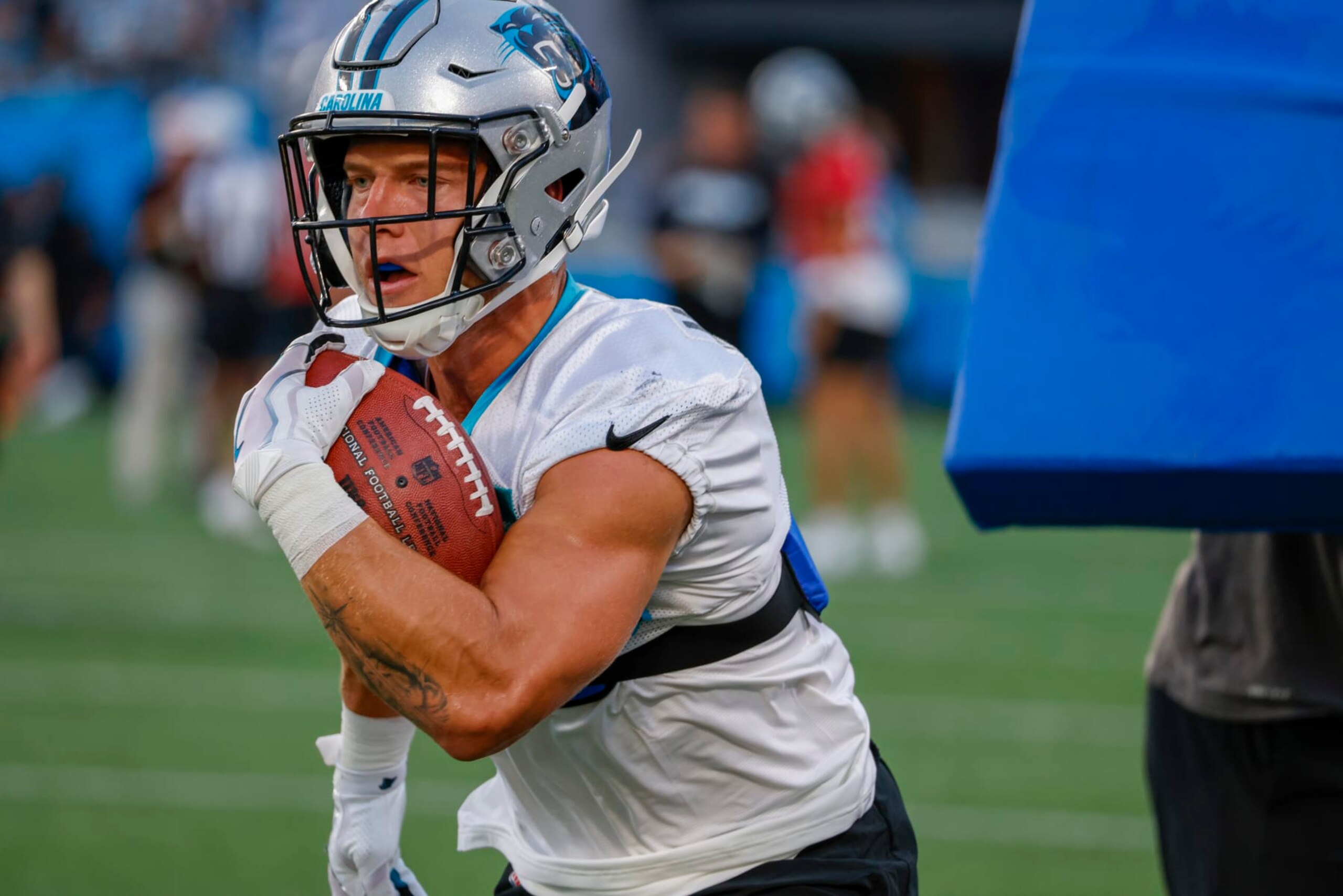 Carolina Panthers running back Christian McCaffrey carries the football during a drill at the NFL football team's Fan Fest in Charlotte, N.C., Thursday, Aug. 11, 2022. (AP Photo/Nell Redmond)