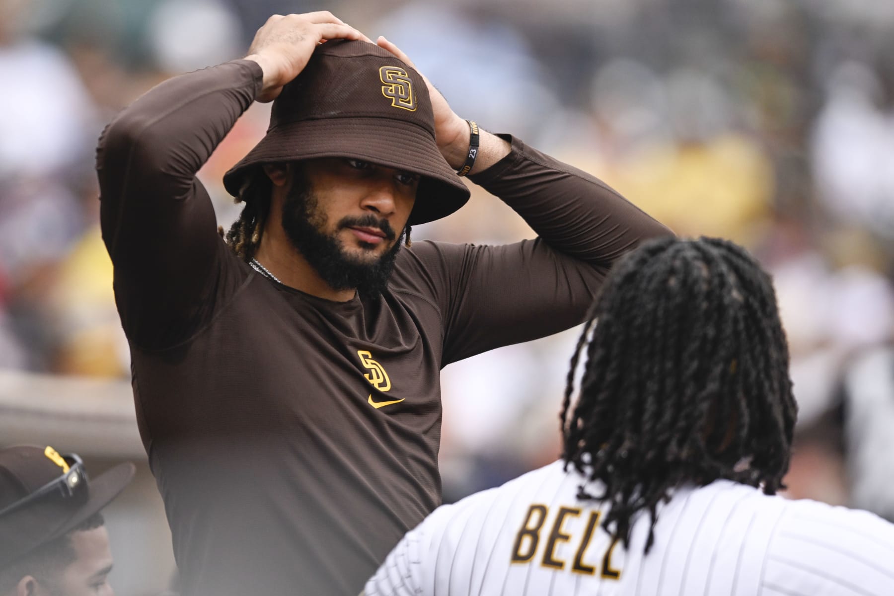 SAN DIEGO, CA - AUGUST 4: Fernando Tatis Jr. #23 of the San Diego Padres talks with Josh Bell #24 during a baseball game against the Colorado Rockies August 4, 2022 at Petco Park in San Diego, California. (Photo by Denis Poroy/Getty Images)