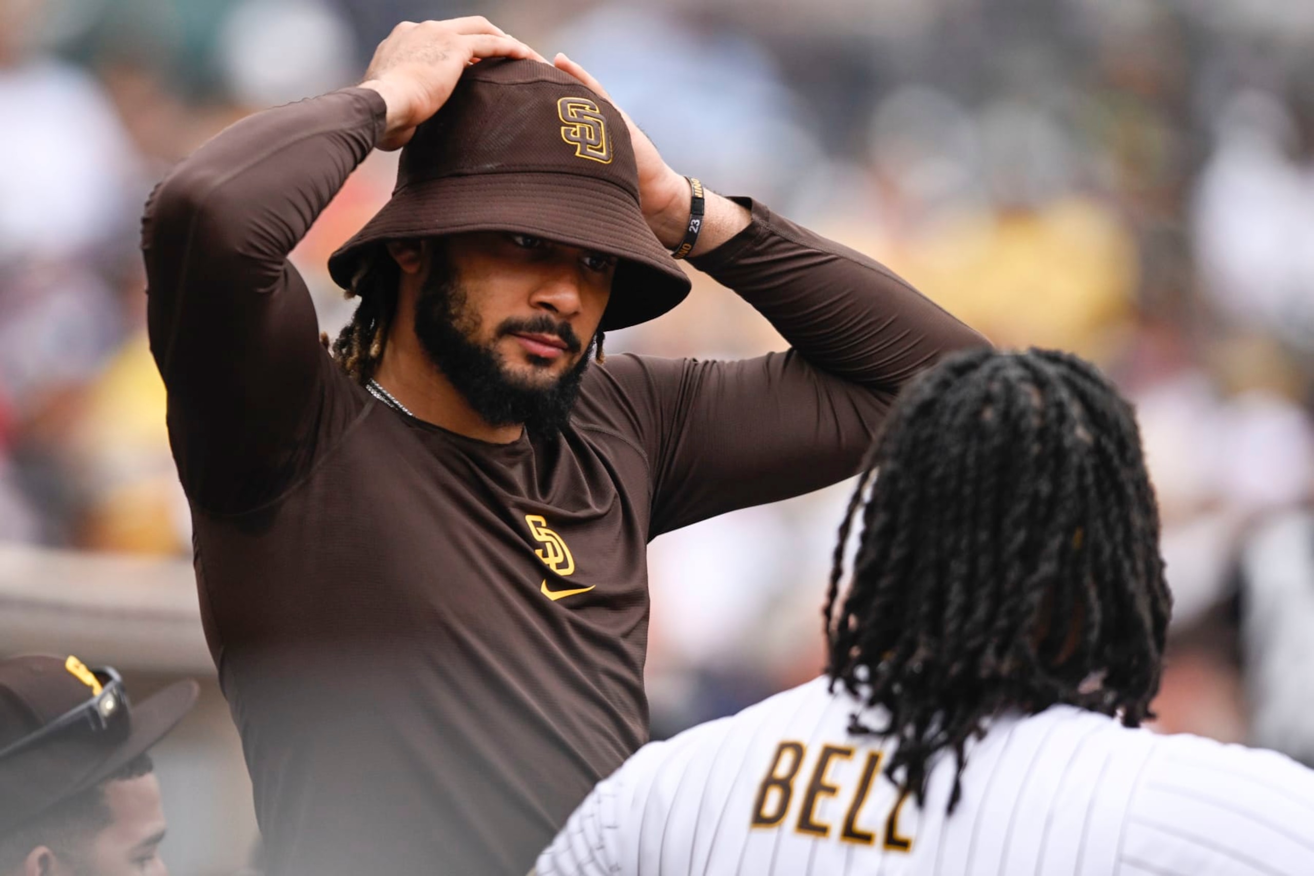 SAN DIEGO, CA - AUGUST 4: Fernando Tatis Jr. #23 of the San Diego Padres talks with Josh Bell #24 during a baseball game against the Colorado Rockies August 4, 2022 at Petco Park in San Diego, California. (Photo by Denis Poroy/Getty Images)