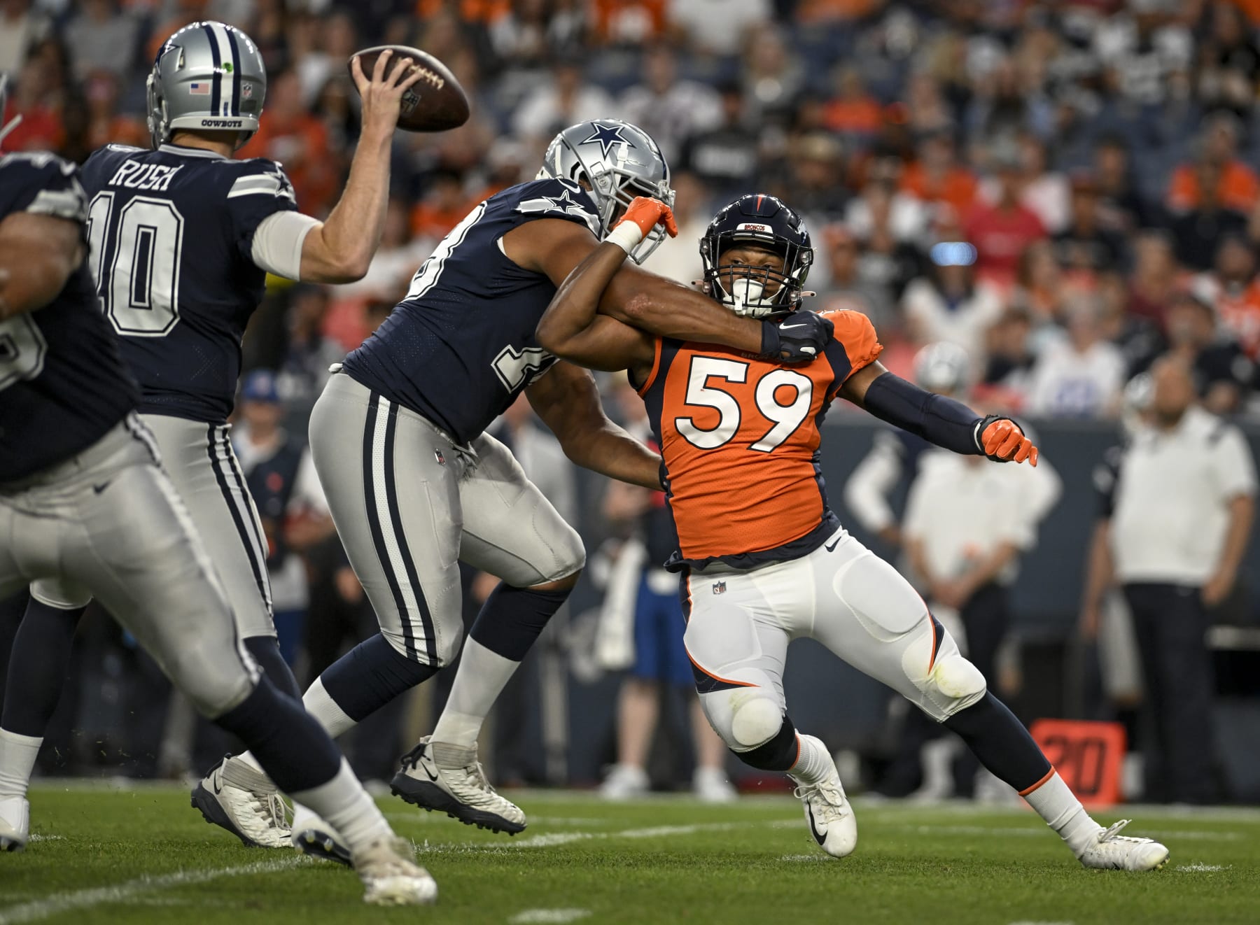DENVER, CO - AUGUST 13: Terence Steele (78) of the Dallas Cowboys blocks Malik Reed (59) of the Denver Broncos as Cooper Rush (10) throws during the first quarter at Empower Field at Mile High on Saturday, August 13, 2022. (Photo by AAron Ontiveroz/MediaNews Group/The Denver Post via Getty Images)