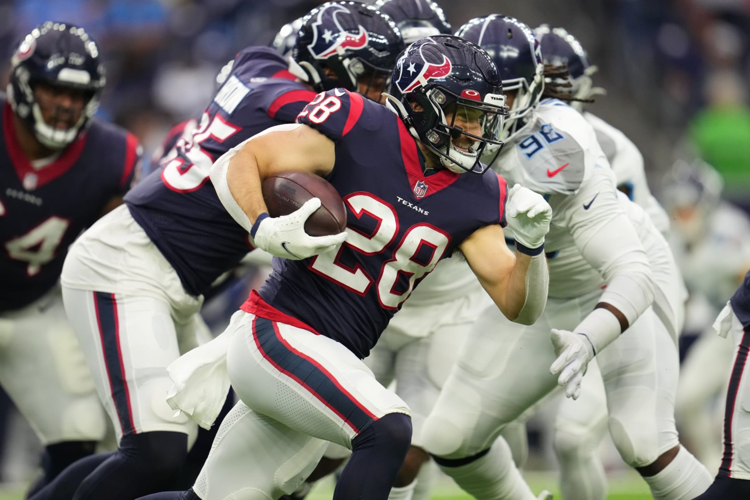 HOUSTON, TEXAS - JANUARY 09: Rex Burkhead #28 of the Houston Texans runs the ball against the Tennessee Titans during an NFL game at NRG Stadium on January 09, 2022 in Houston, Texas. (Photo by Cooper Neill/Getty Images)