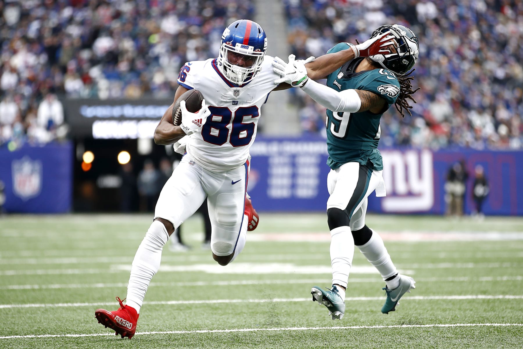 EAST RUTHERFORD, NEW JERSEY - NOVEMBER 28: Darius Slayton #86 of the New York Giants fends off a tackle attempt by Avonte Maddox #29 of the Philadelphia Eagles in the third quarter at MetLife Stadium on November 28, 2021 in East Rutherford, New Jersey. (Photo by Sarah Stier/Getty Images)