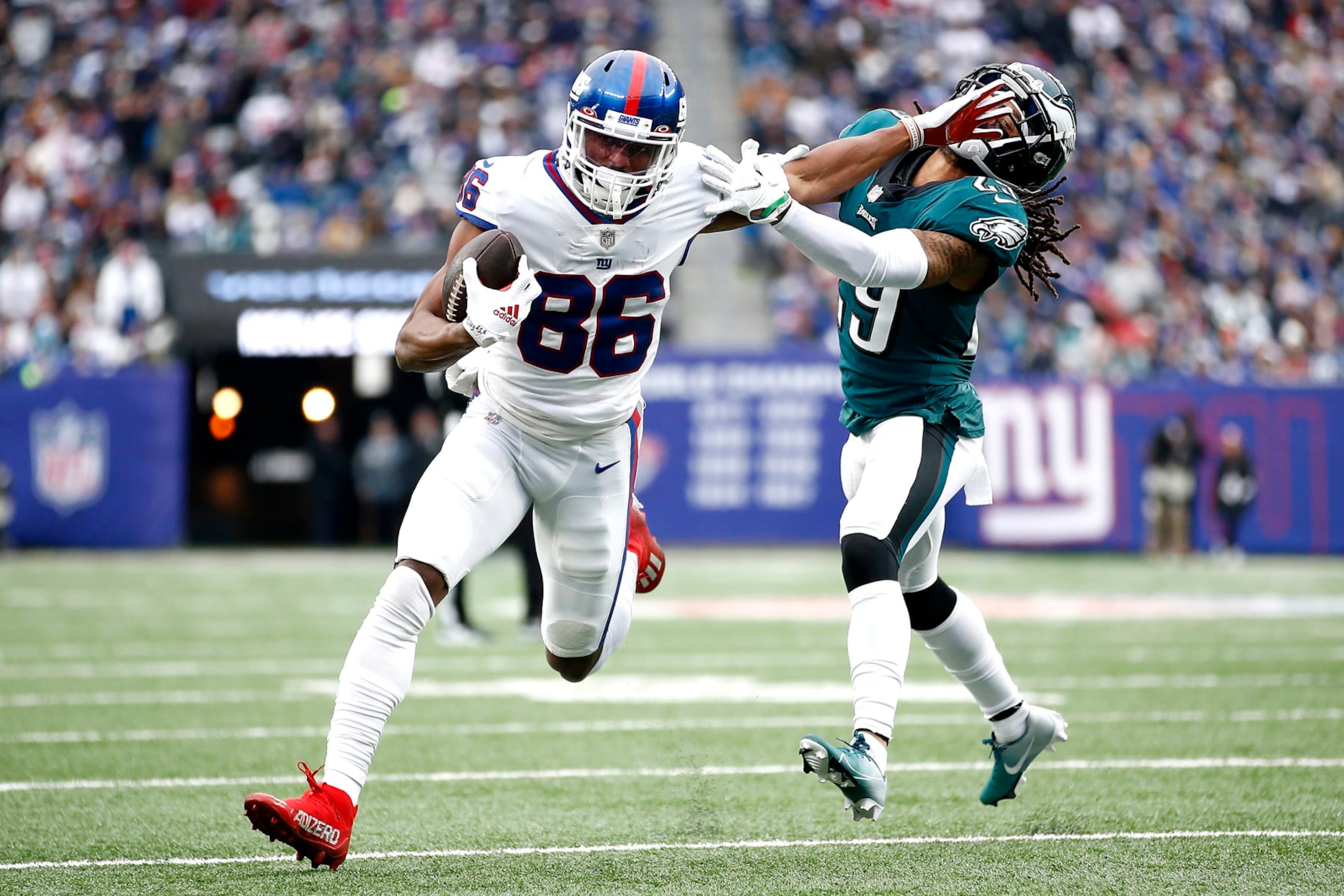 EAST RUTHERFORD, NEW JERSEY - NOVEMBER 28: Darius Slayton #86 of the New York Giants fends off a tackle attempt by Avonte Maddox #29 of the Philadelphia Eagles in the third quarter at MetLife Stadium on November 28, 2021 in East Rutherford, New Jersey. (Photo by Sarah Stier/Getty Images)