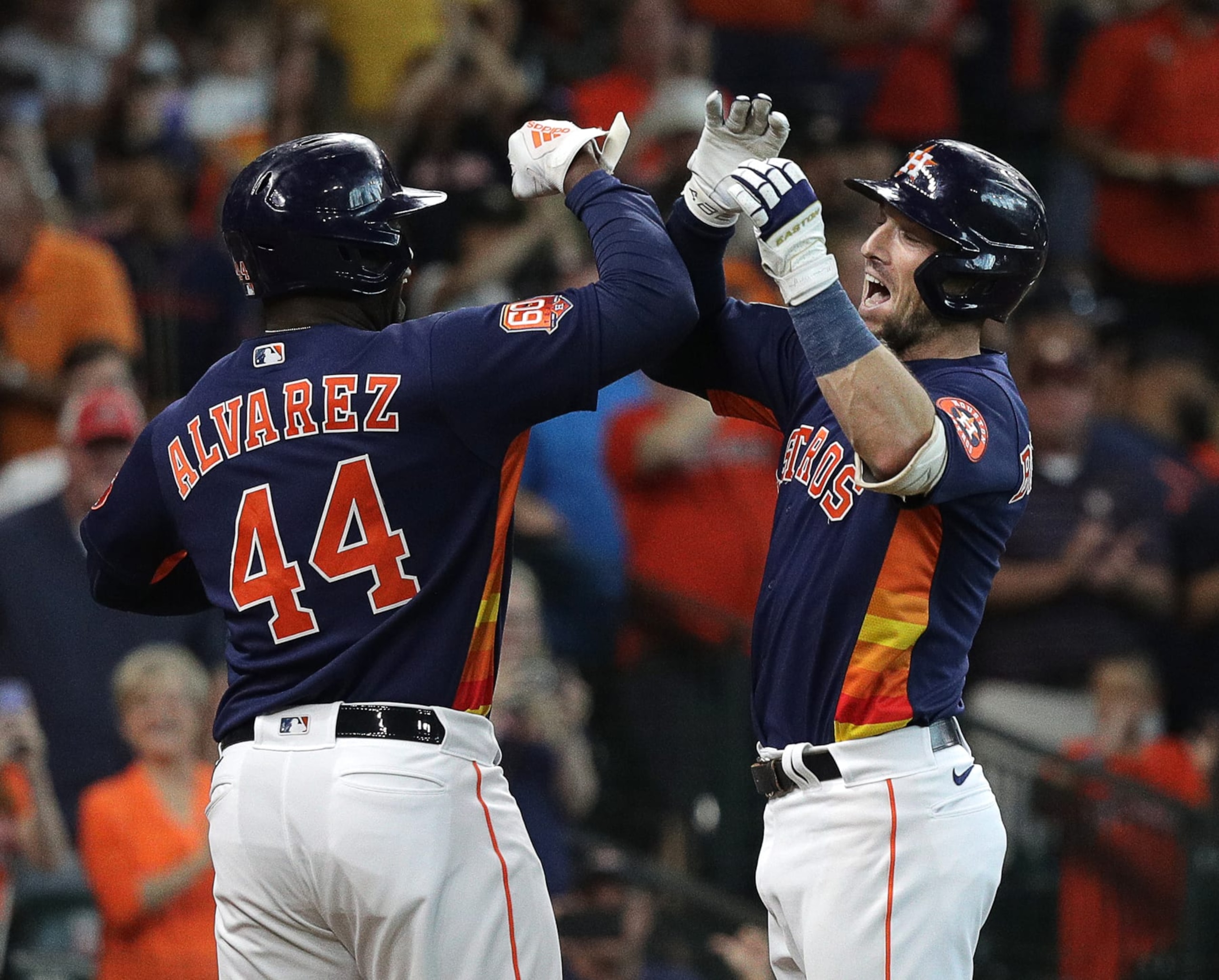 HOUSTON, TEXAS - AUGUST 14: Alex Bregman #2 of the Houston Astros receives a high five from Yordan Alvarez #44 after hitting a two run home run in the first inning against the Oakland Athletics at Minute Maid Park on August 14, 2022 in Houston, Texas. (Photo by Bob Levey/Getty Images)