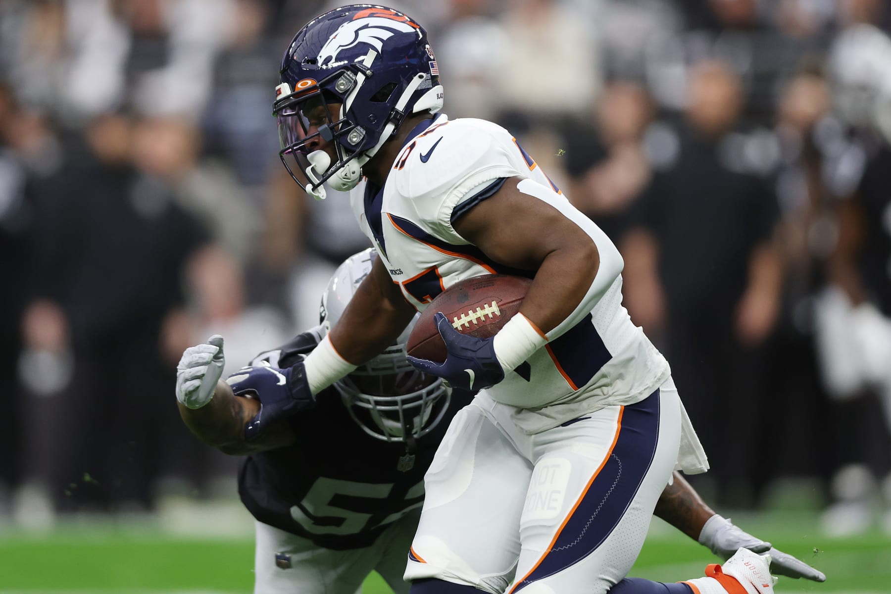 LAS VEGAS, NEVADA - DECEMBER 26: Javonte Williams #33 of the Denver Broncos runs with the ball after the catch against the Las Vegas Raiders in the first quarter at Allegiant Stadium on December 26, 2021 in Las Vegas, Nevada. (Photo by Matthew Stockman/Getty Images)