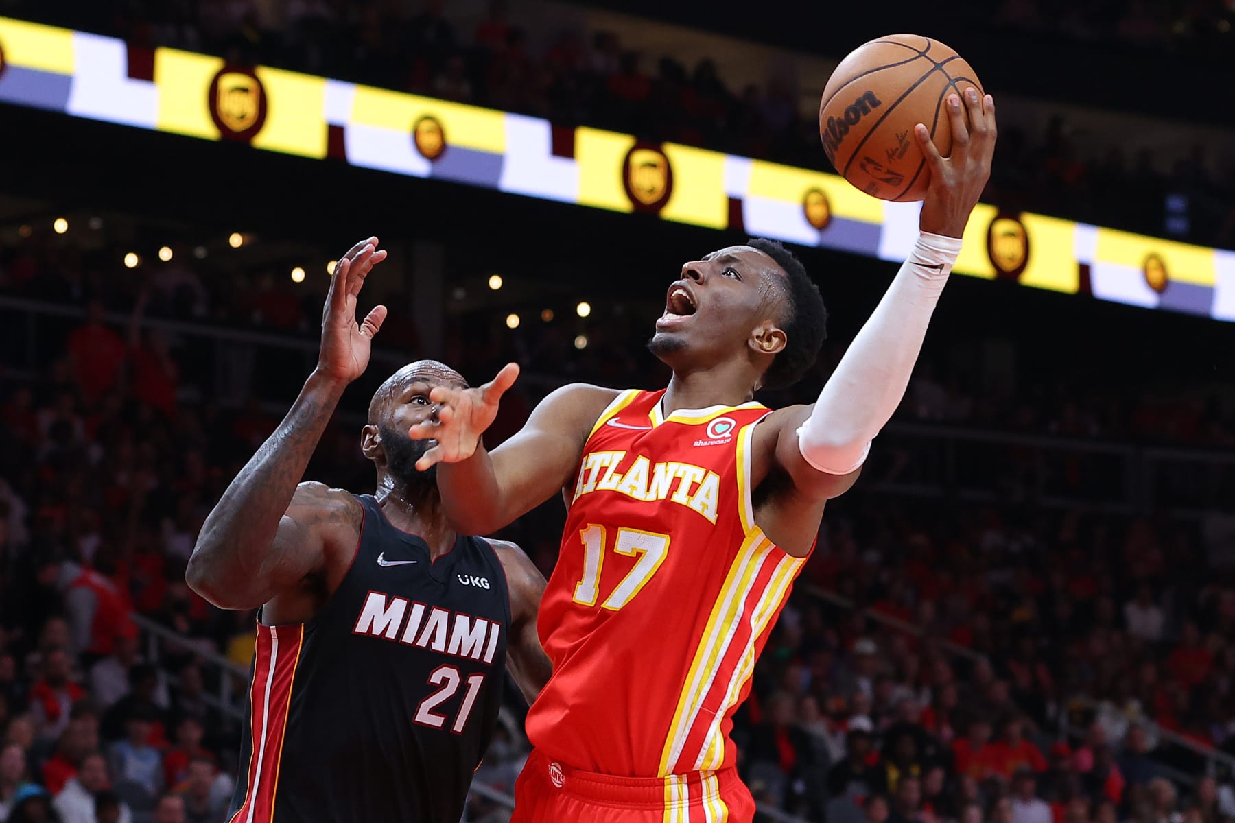 ATLANTA, GEORGIA - APRIL 22: Onyeka Okongwu #17 of the Atlanta Hawks shoots against Dewayne Dedmon #21 of the Miami Heat during second half in Game Three of the Eastern Conference First Round at State Farm Arena on April 22, 2022 in Atlanta, Georgia. NOTE TO USER: User expressly acknowledges and agrees that, by downloading and or using this photograph, User is consenting to the terms and conditions of the Getty Images License Agreement.  (Photo by Kevin C. Cox/Getty Images)