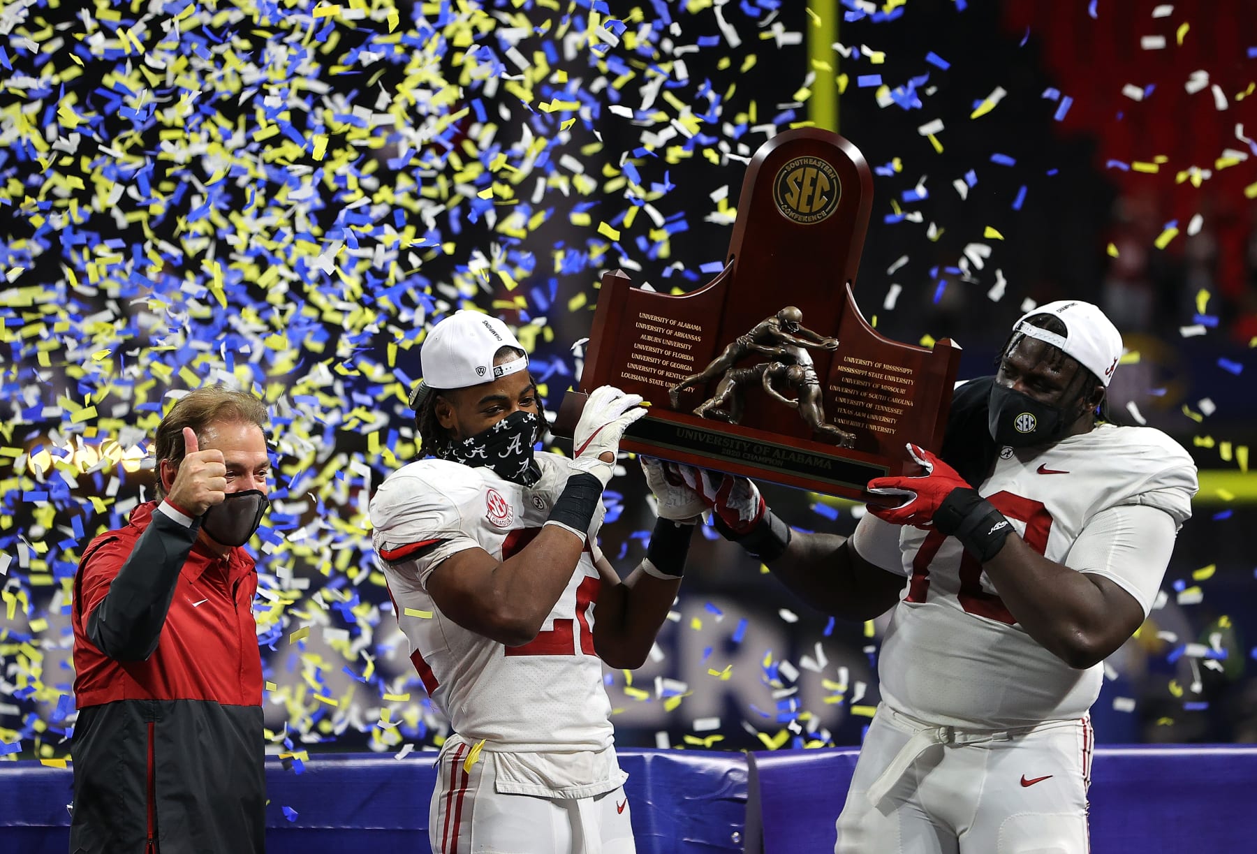 ATLANTA, GEORGIA - DECEMBER 19:  Head coach Nick Saban, Najee Harris #22, and Alex Leatherwood #70 of the Alabama Crimson Tide hold up the trophy as they celebrate their 52-46 win over the Florida Gators in the SEC Championship at Mercedes-Benz Stadium on December 19, 2020 in Atlanta, Georgia. (Photo by Kevin C. Cox/Getty Images)