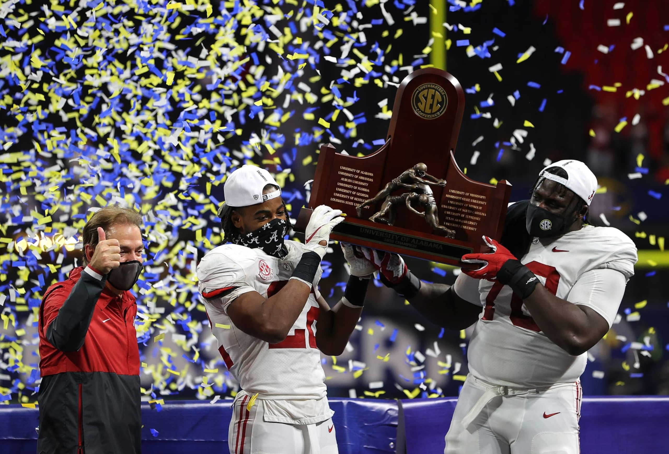 ATLANTA, GEORGIA - DECEMBER 19:  Head coach Nick Saban, Najee Harris #22, and Alex Leatherwood #70 of the Alabama Crimson Tide hold up the trophy as they celebrate their 52-46 win over the Florida Gators in the SEC Championship at Mercedes-Benz Stadium on December 19, 2020 in Atlanta, Georgia. (Photo by Kevin C. Cox/Getty Images)