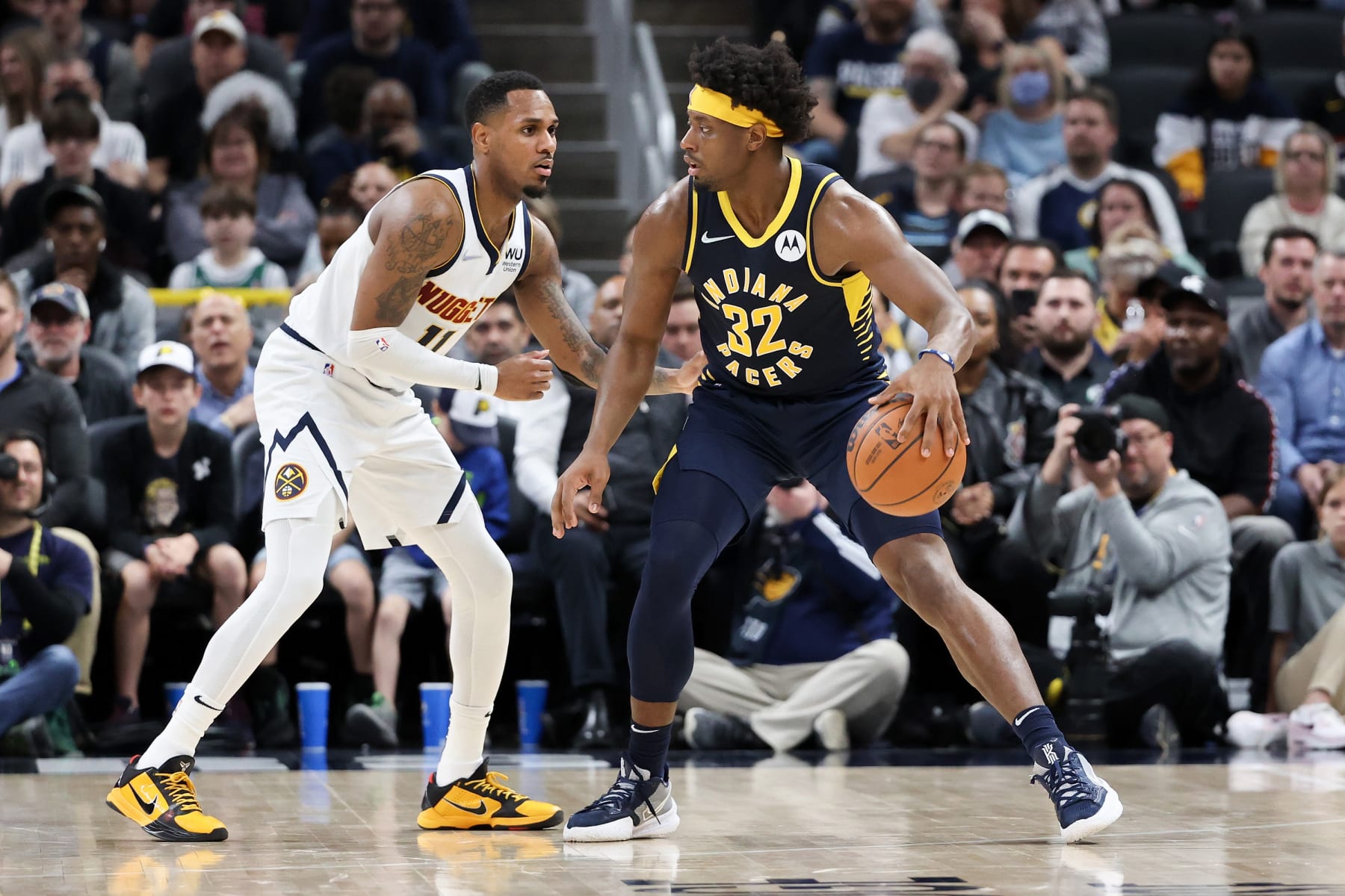 INDIANAPOLIS, INDIANA - MARCH 30: Terry Taylor #32 of the Indiana Pacers dribbles the ball while being guarded by Monte Morris #11 of the Denver Nuggets in the third quarter at Gainbridge Fieldhouse on March 30, 2022 in Indianapolis, Indiana. NOTE TO USER: User expressly acknowledges and agrees that, by downloading and or using this Photograph, user is consenting to the terms and conditions of the Getty Images License Agreement. (Photo by Dylan Buell/Getty Images)