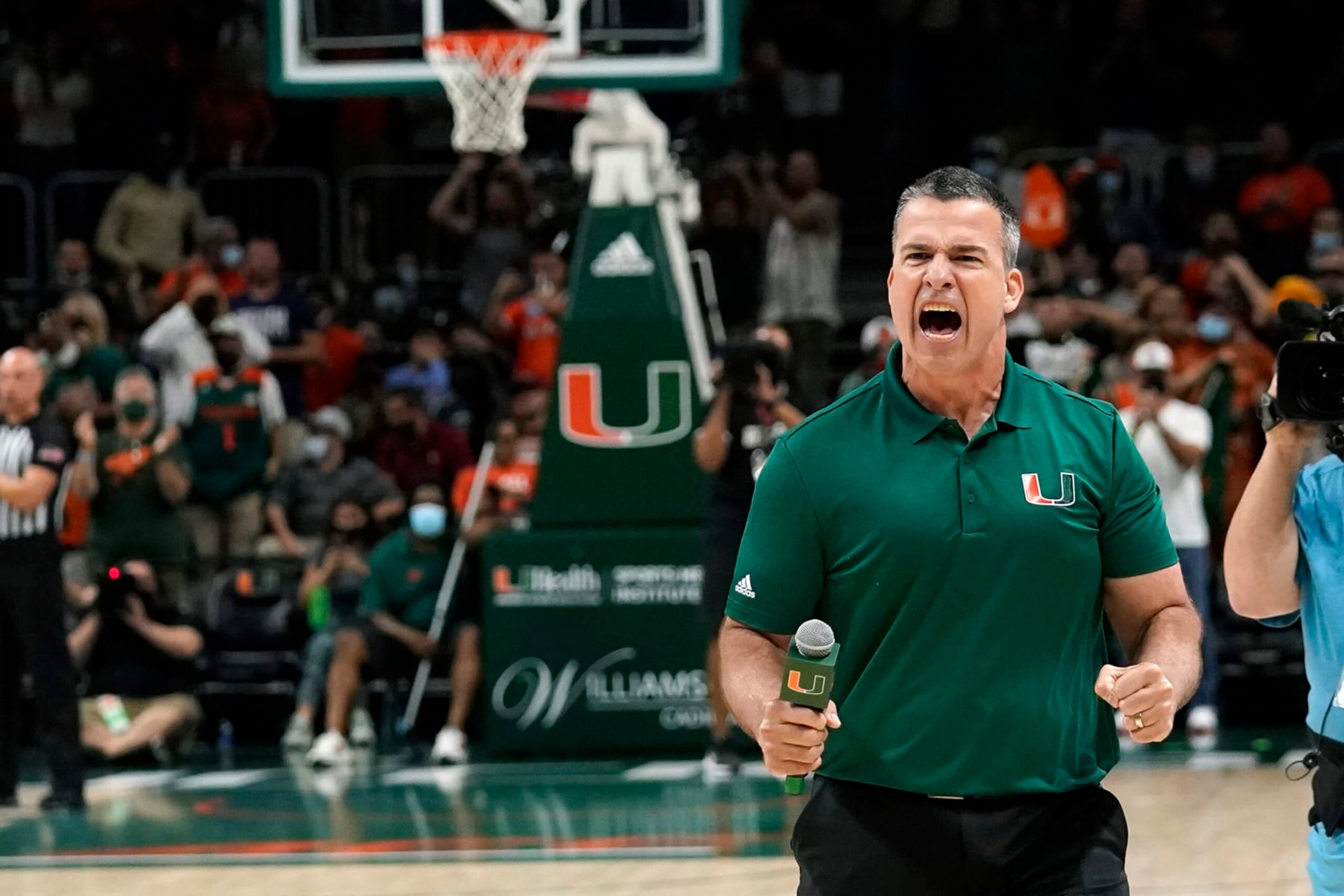 Miami head football coach Mario Cristobal encourages the crowd during the second half of an NCAA college basketball game between Miami and Florida State, Saturday, Jan. 22, 2022, in Coral Gables, Fla. Florida State won 61-60. (AP Photo/Lynne Sladky)