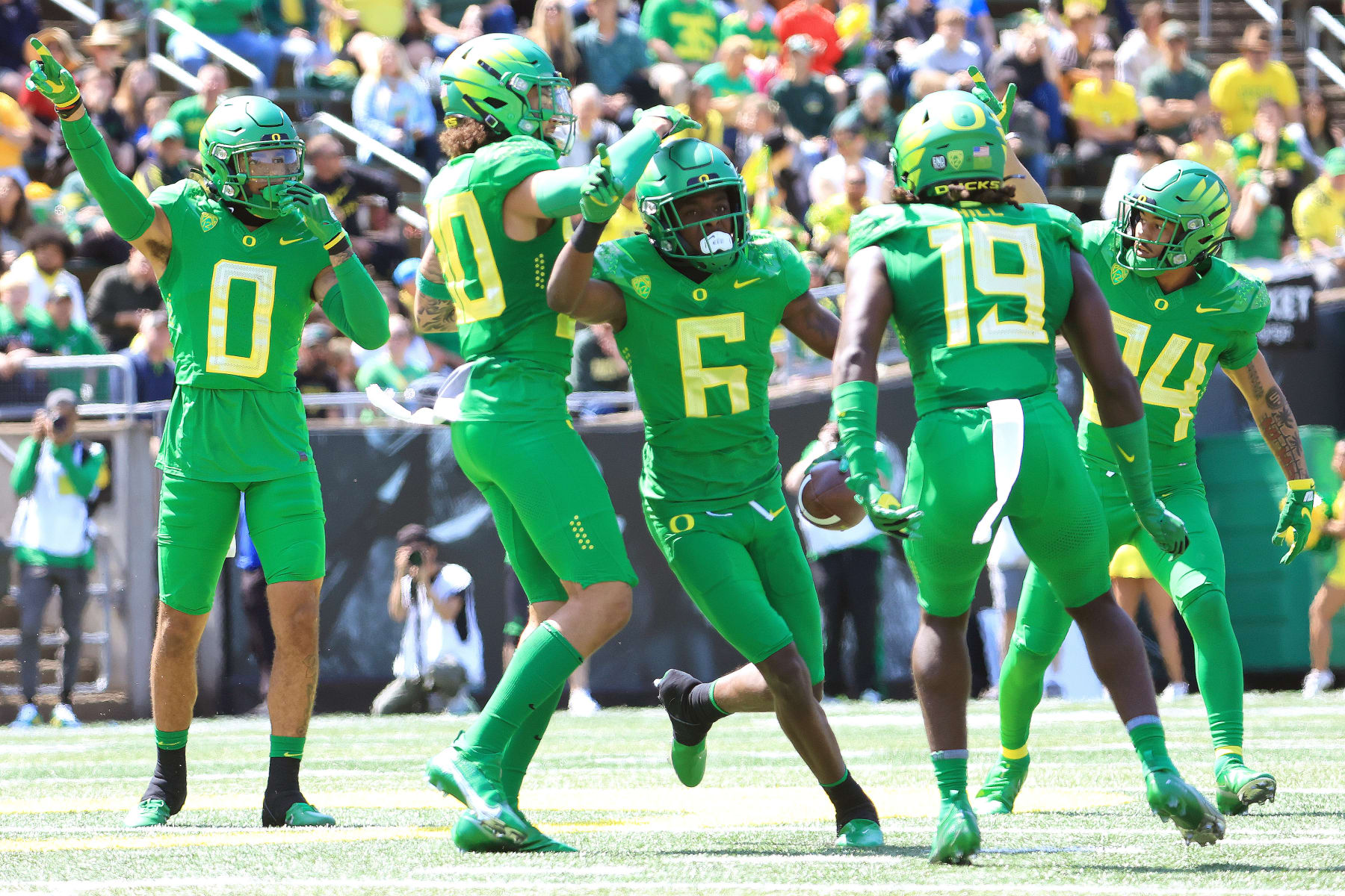 EUGENE, OREGON - APRIL 23: Jahlil Florence #6 of Team Green celebrates with teammates after intercepting a pass during the first quarter against Team Yellow during the Oregon Spring Game at Autzen Stadium on April 23, 2022 in Eugene, Oregon. (Photo by Abbie Parr/Getty Images)