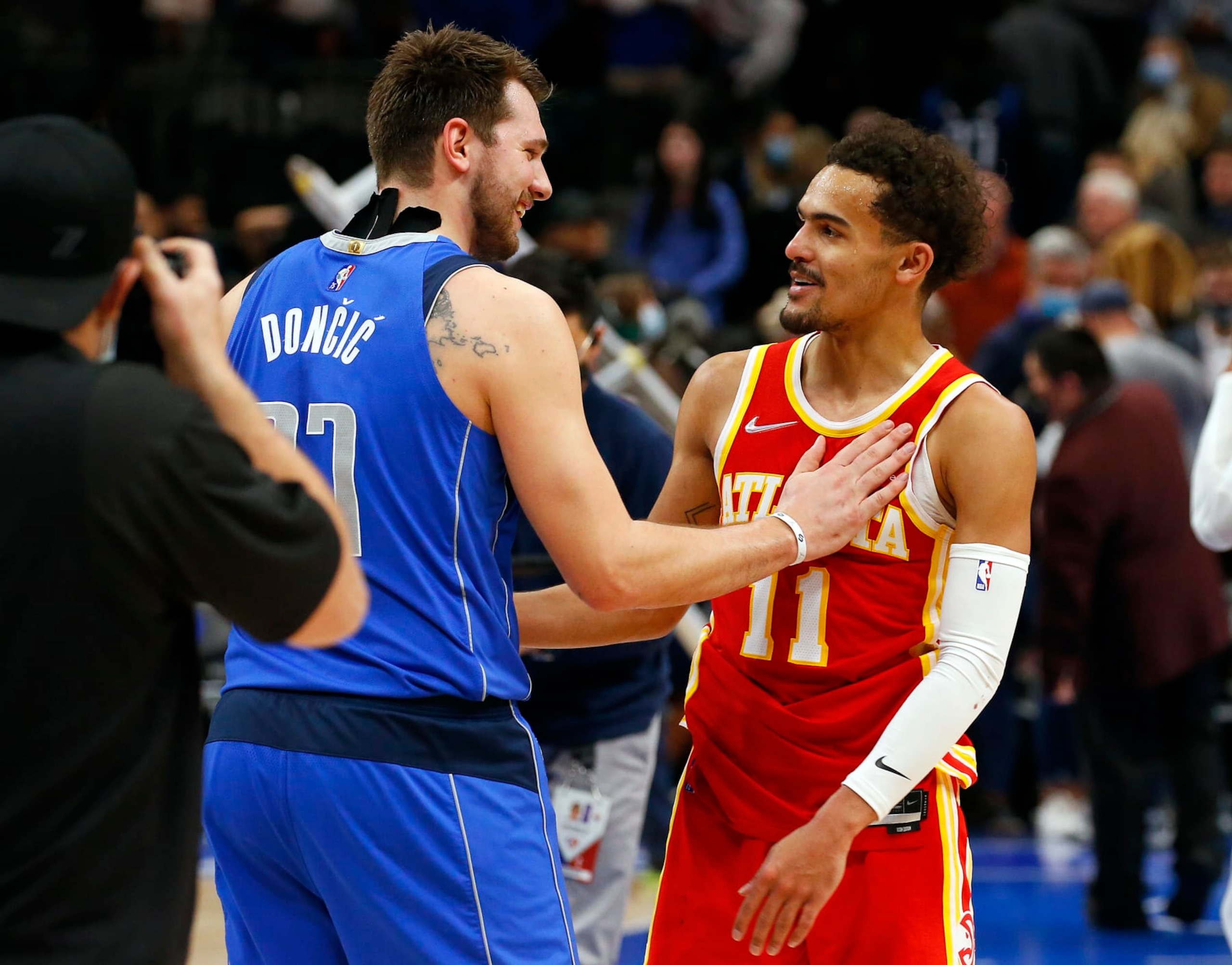 DALLAS, TEXAS - FEBRUARY 06: Luka Doncic #77 of the Dallas Mavericks has a moment with Trae Young #11 of the Atlanta Hawks after the game at American Airlines Center on February 06, 2022 in Dallas, Texas. NOTE TO USER: User expressly acknowledges and agrees that, by downloading and or using this photograph, User is consenting to the terms and conditions of the Getty Images License Agreement. (Photo by Richard Rodriguez/Getty Images)