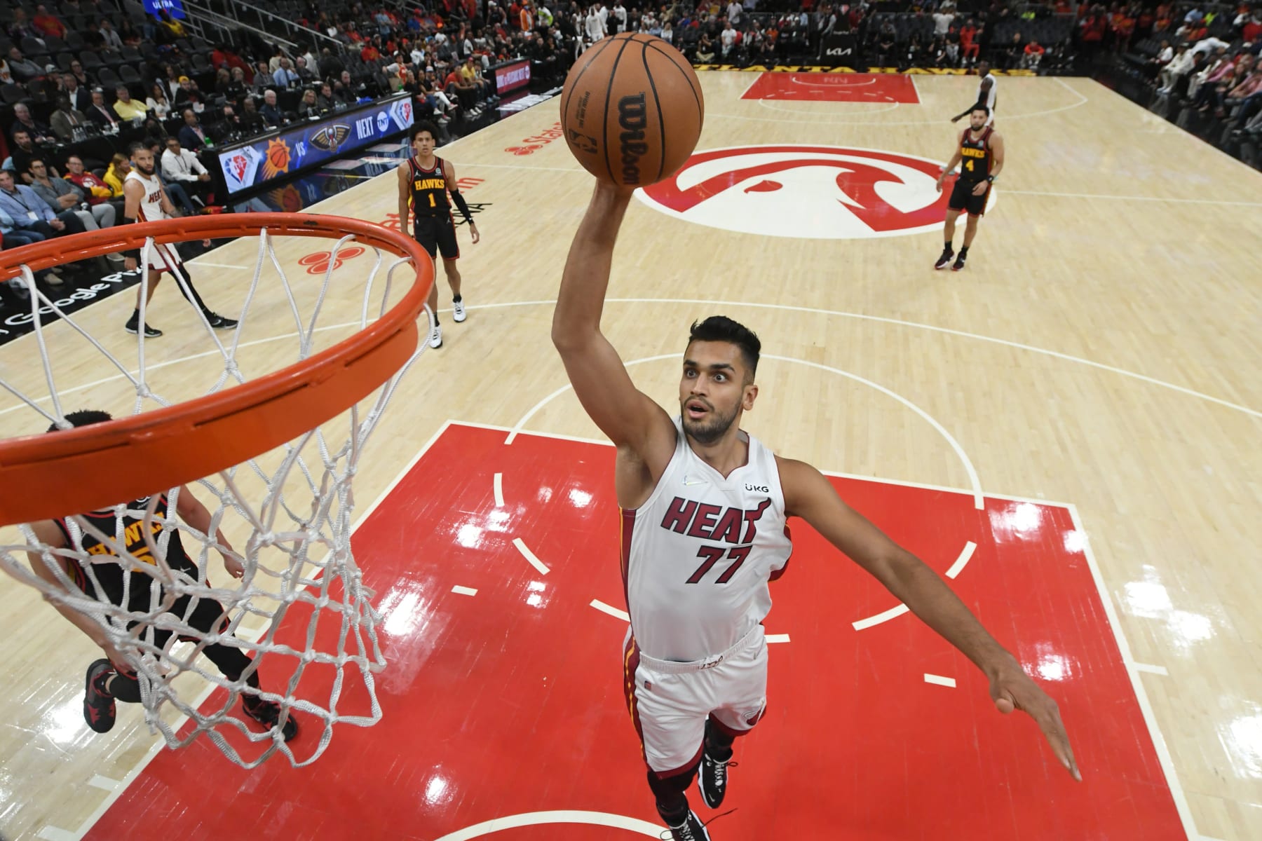 ATLANTA, GA - APRIL 24: Omer Yurtseven #77 of the Miami Heat dunks the ball against the Atlanta Hawks during Round 1 Game 4 of the 2022 NBA Playoffs on April 24, 2022 at State Farm Arena in Atlanta, Georgia.  NOTE TO USER: User expressly acknowledges and agrees that, by downloading and/or using this Photograph, user is consenting to the terms and conditions of the Getty Images License Agreement. Mandatory Copyright Notice: Copyright 2022 NBAE (Photo by Adam Hagy/NBAE via Getty Images)
