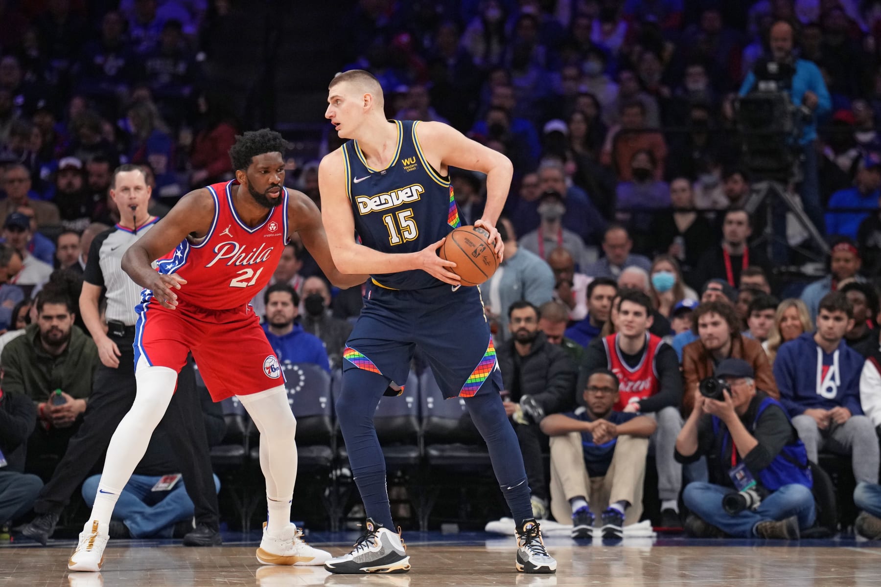 PHILADELPHIA, PA - MARCH 14: Nikola Jokic #15 of the Denver Nuggets handles the ball against Joel Embiid #21 of the Philadelphia 76ers on March 14, 2022 at Wells Fargo Center in Philadelphia, Pennsylvania. NOTE TO USER: User expressly acknowledges and agrees that, by downloading and/or using this Photograph, user is consenting to the terms and conditions of the Getty Images License Agreement. Mandatory Copyright Notice: Copyright 2022 NBAE (Photo by Jesse D. Garrabrant/NBAE via Getty Images)