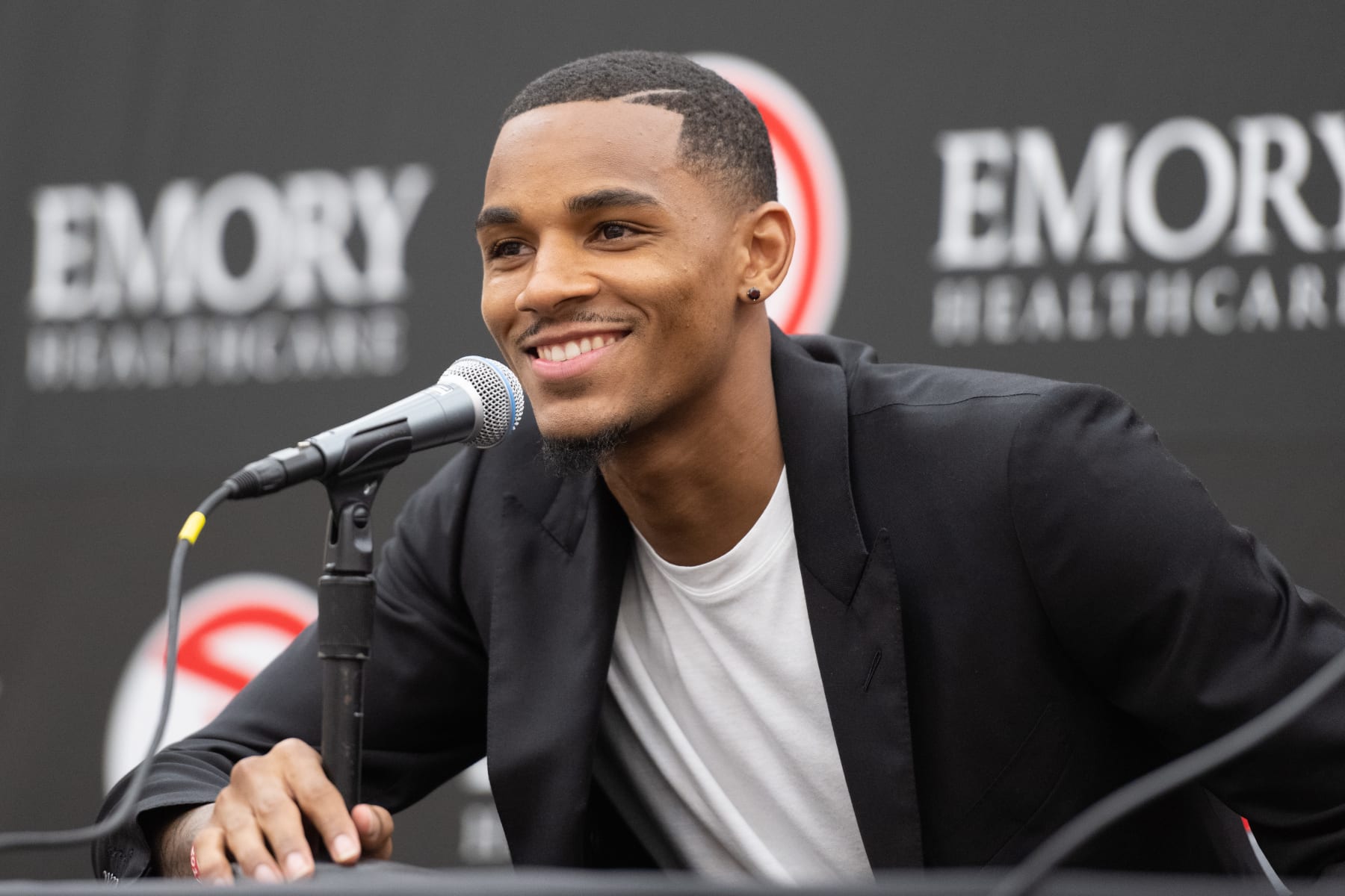 ATLANTA, GA - JULY 1: Dejounte Murray of the Atlanta Hawks talks to the media during the introductory draft press conference on July 1, 2022 at State Farm Arena in Atlanta, Georgia.  NOTE TO USER: User expressly acknowledges and agrees that, by downloading and/or using this Photograph, user is consenting to the terms and conditions of the Getty Images License Agreement. Mandatory Copyright Notice: Copyright 2022 NBAE (Photo by Adam Hagy/NBAE via Getty Images)