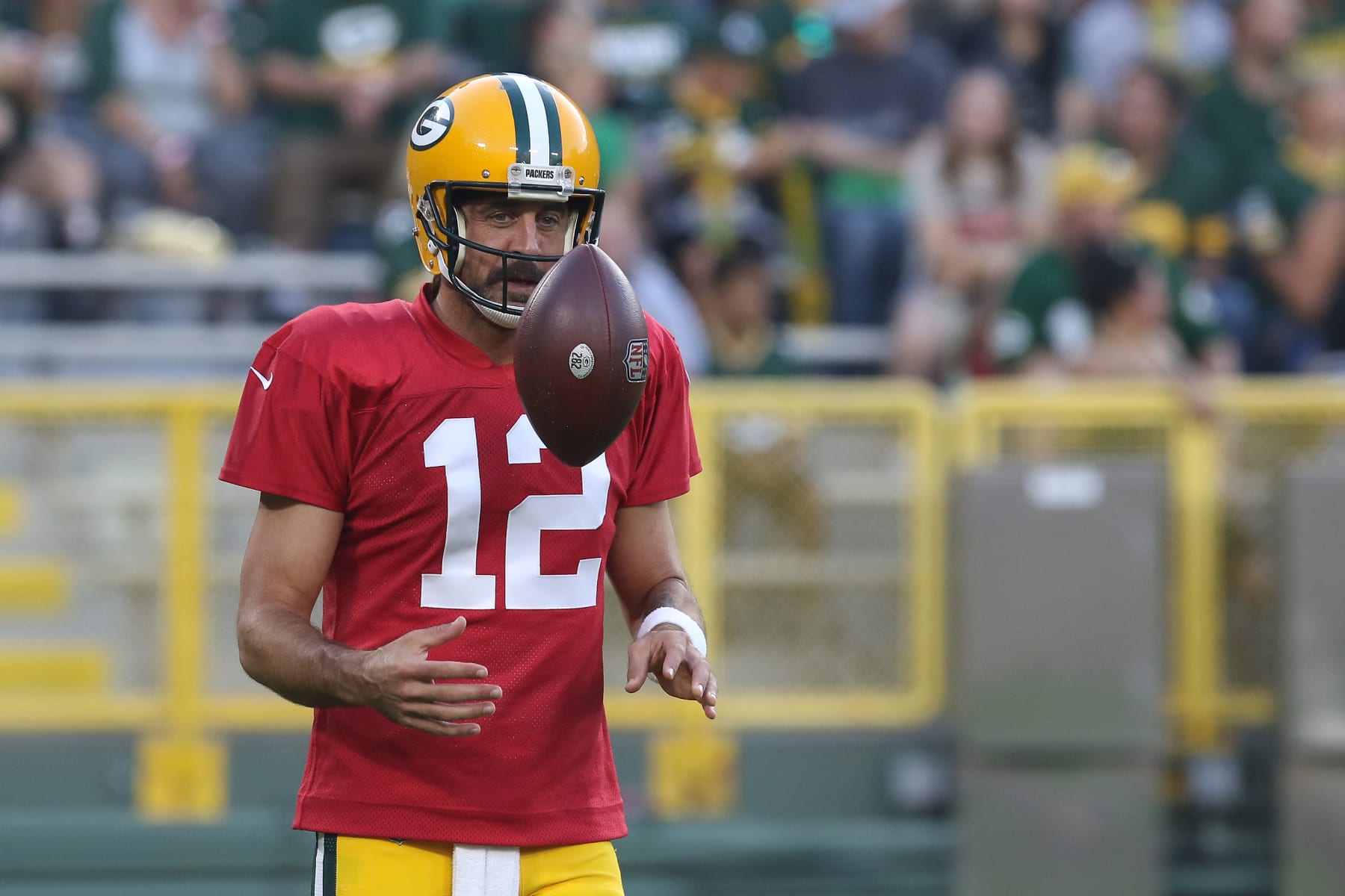 ASHWAUBENON, WI - AUGUST 05: Green Bay Packers quarterback Aaron Rodgers (12) flips a ball during Green Bay Packers Family Night at Lambeau Field, on August 5, 2022 in Green Bay, WI. (Photo by Larry Radloff/Icon Sportswire via Getty Images)