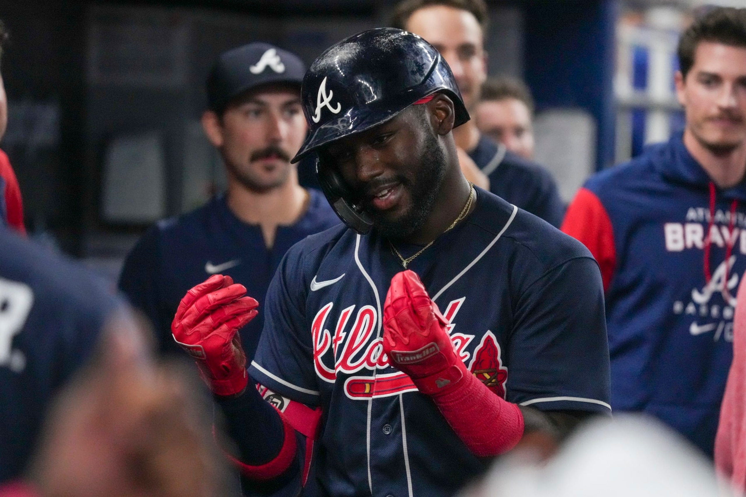 MIAMI, FLORIDA - AUGUST 14: Michael Harris II #23 of the Atlanta Braves celebrates in the dugout with teammates after hitting a home run in the ninth inning against the Miami Marlins at loanDepot park on August 14, 2022 in Miami, Florida. (Photo by Eric Espada/Getty Images)