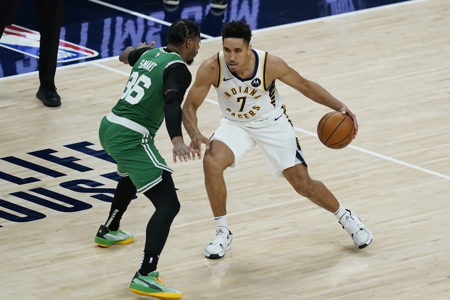 Indiana Pacers' Malcolm Brogdon (7) is defended by Boston Celtics' Marcus Smart (36) during the second half of an NBA basketball game, Tuesday, Dec. 29, 2020, in Indianapolis. (AP Photo/Darron Cummings)
