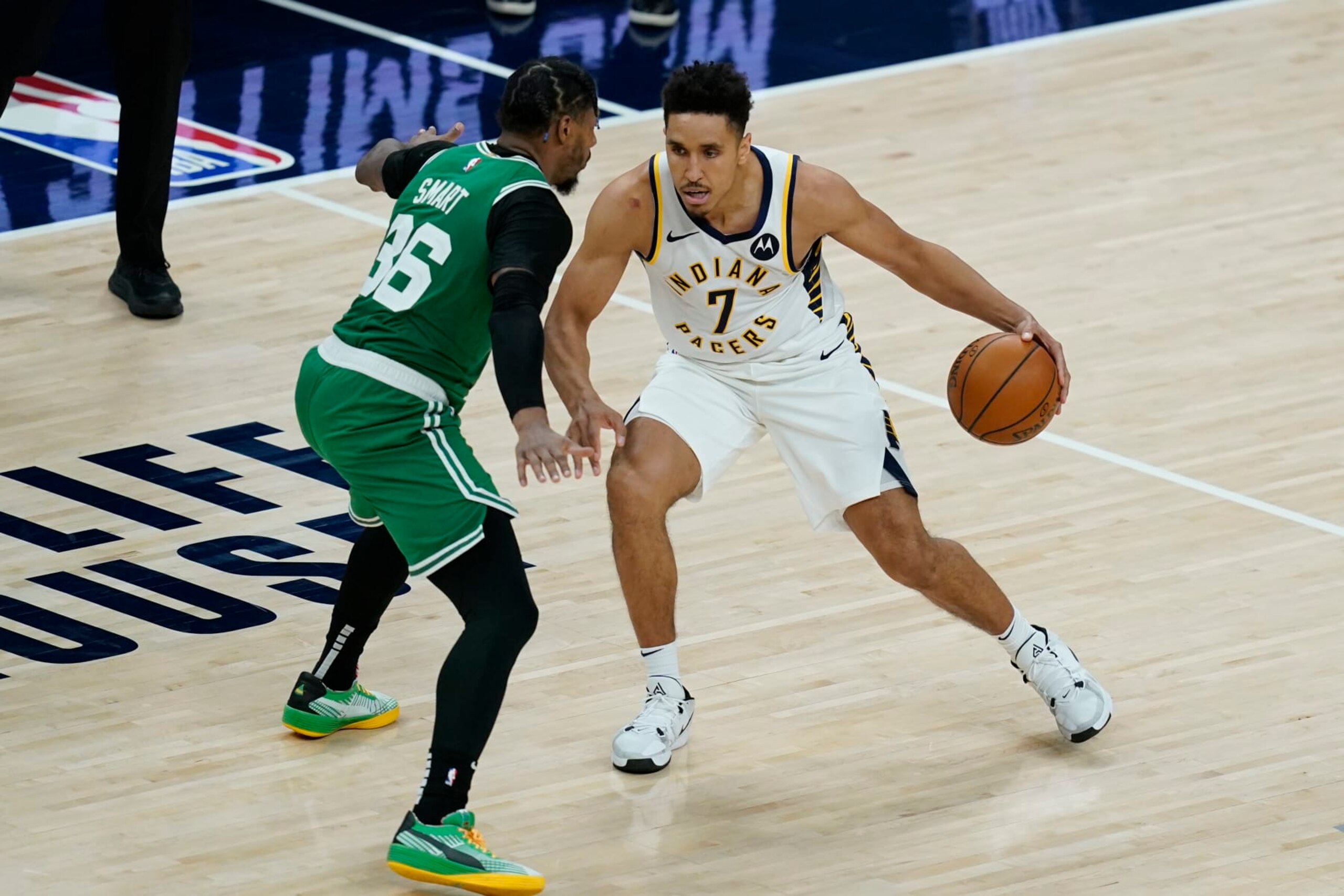 Indiana Pacers' Malcolm Brogdon (7) is defended by Boston Celtics' Marcus Smart (36) during the second half of an NBA basketball game, Tuesday, Dec. 29, 2020, in Indianapolis. (AP Photo/Darron Cummings)